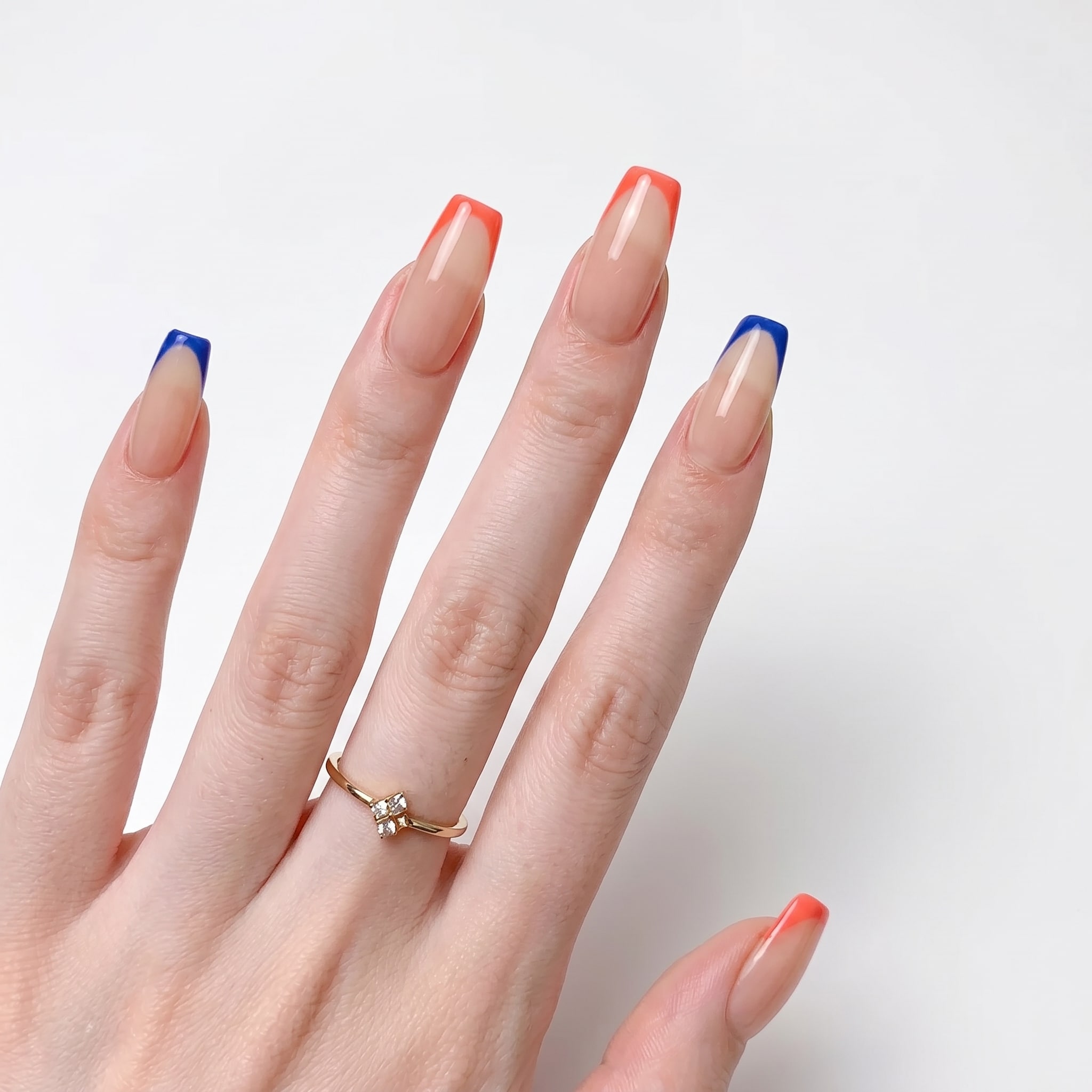 Short nude nails with blue and coral French tips