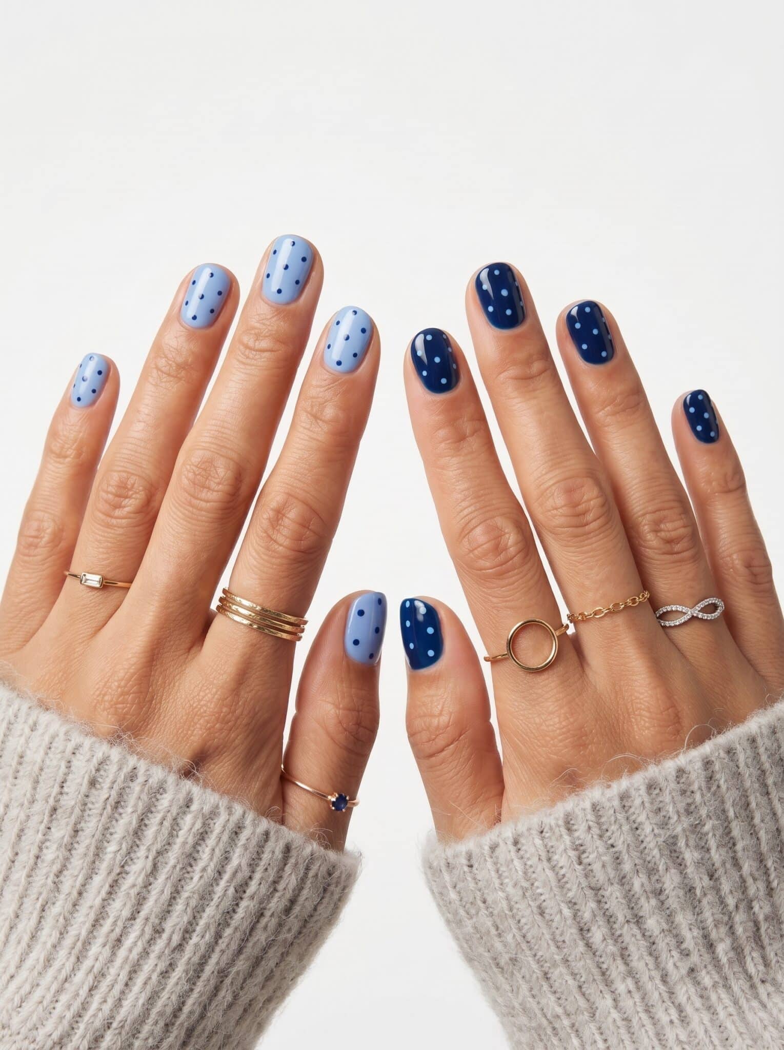 Light blue and navy nails with small white and blue dot accents