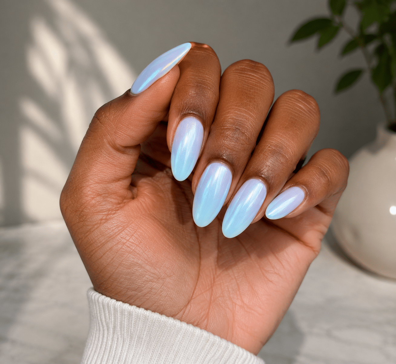 Blue summer nails with a glossy light blue finish on almond nails