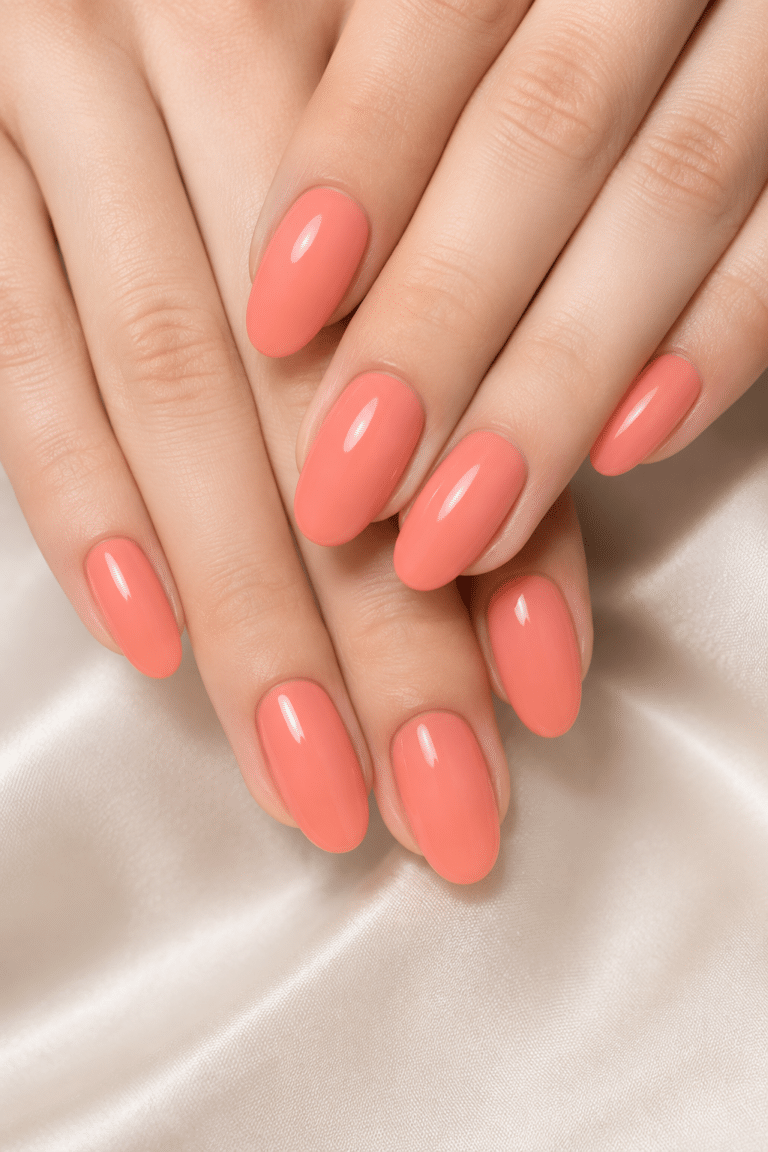 Bright coral summer nails with a glossy almond shape manicure