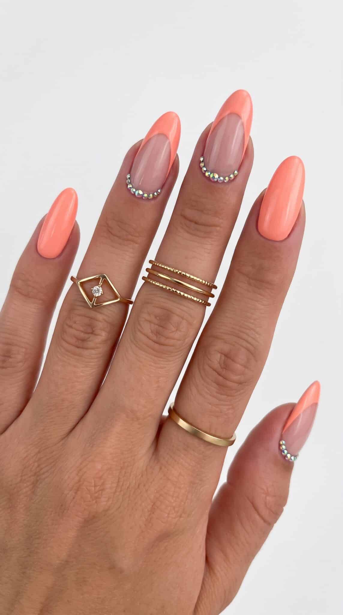 Bright peach almond nails with a high-shine finish