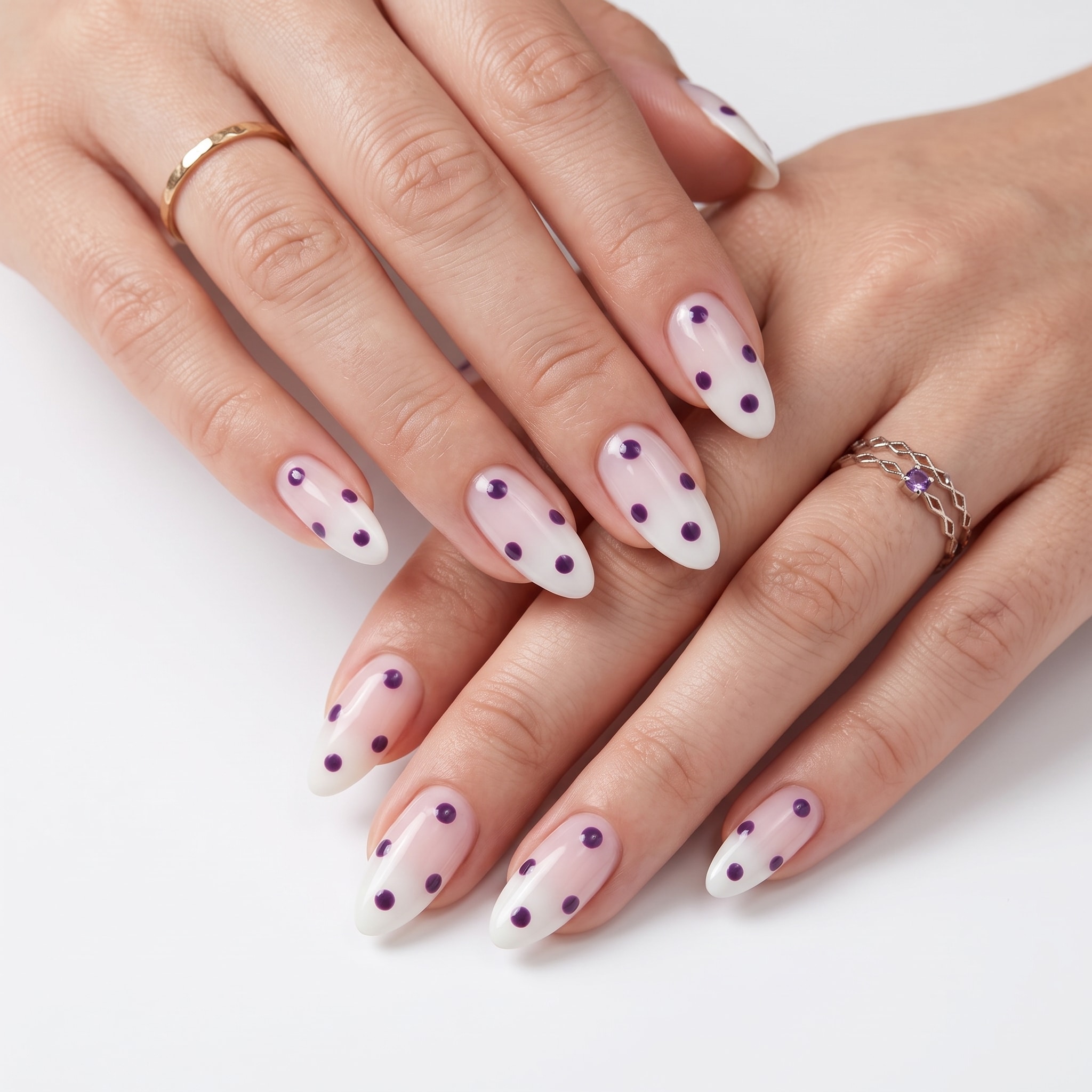 Sheer nude almond nails with small burgundy micro dot details