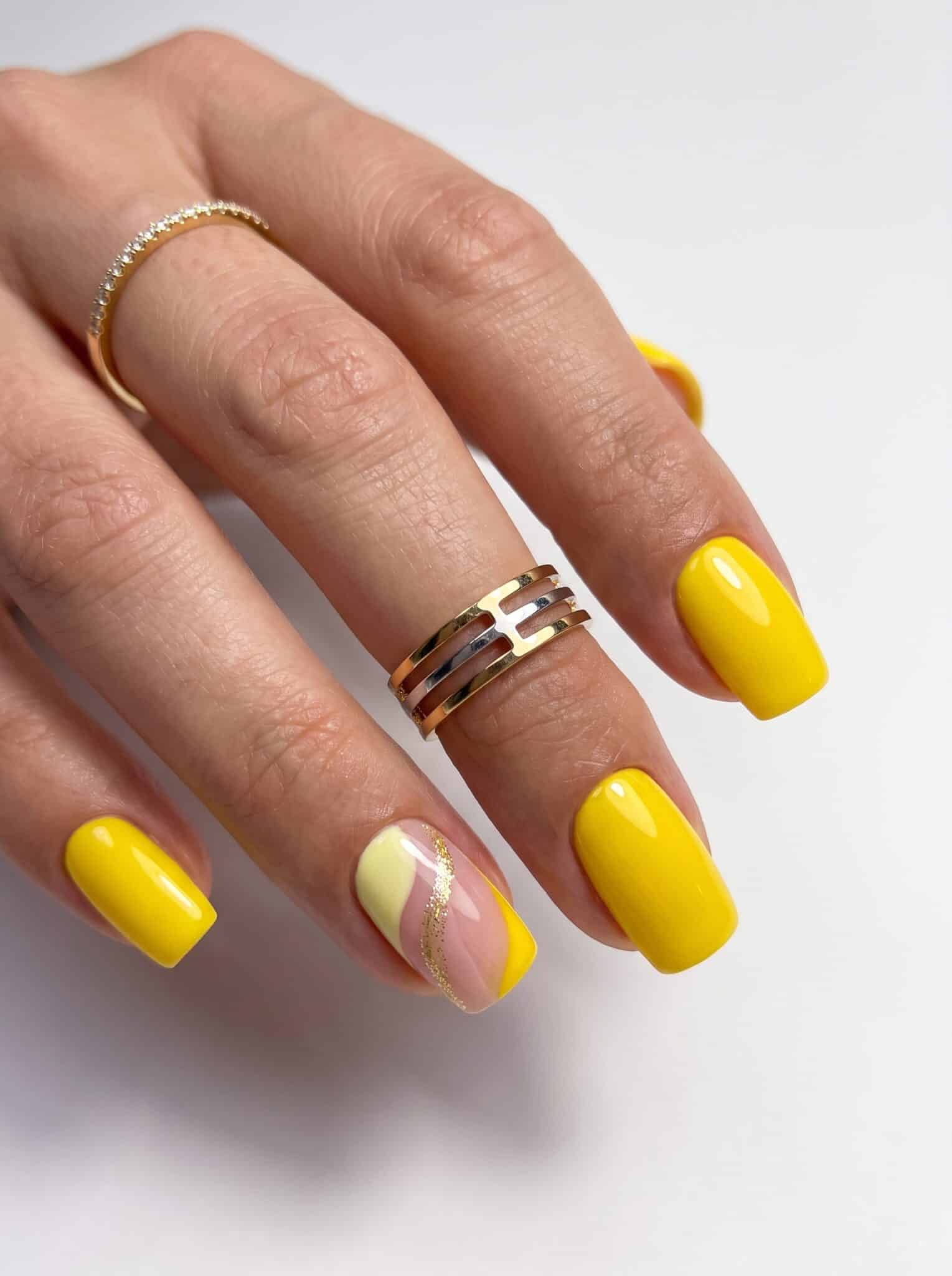 Butter yellow nails with tiny white daisy accents on two hands
