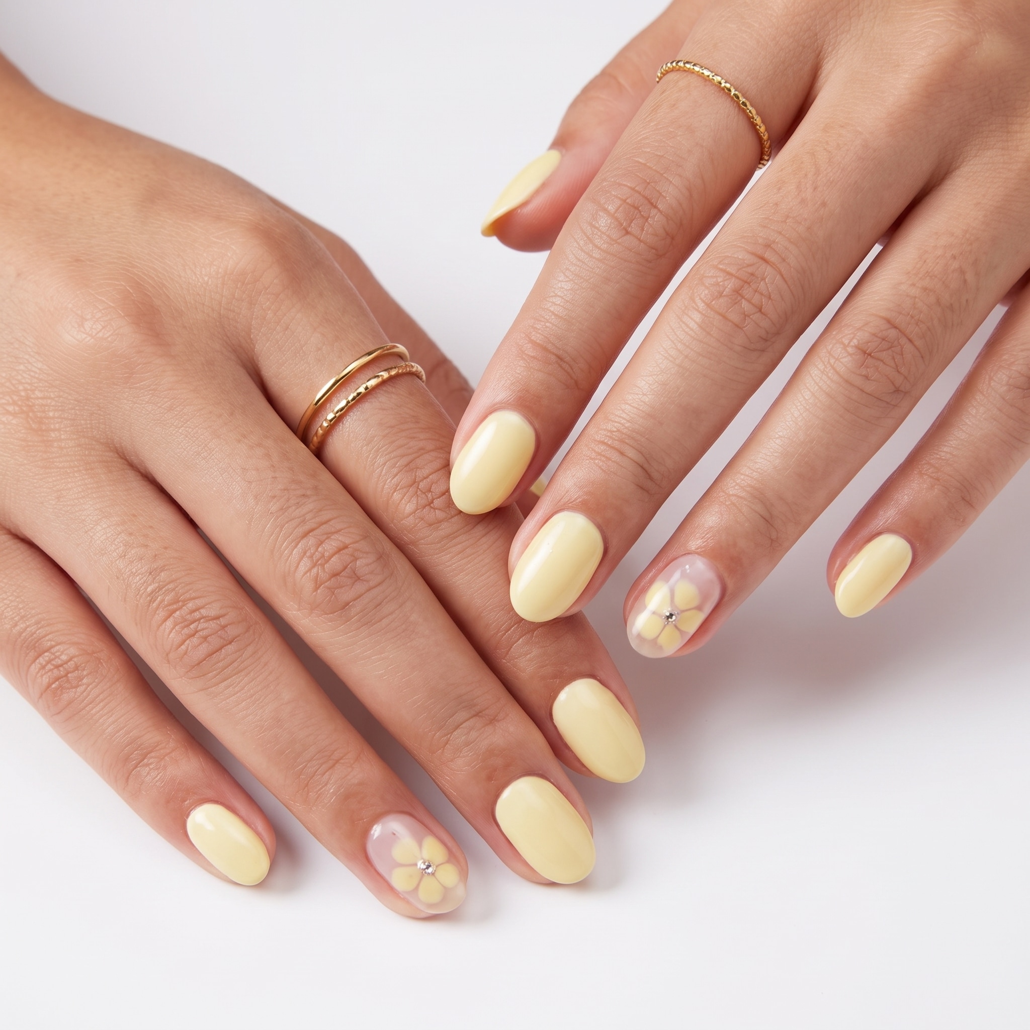 Butter yellow French tip nails with pearly glitter accents