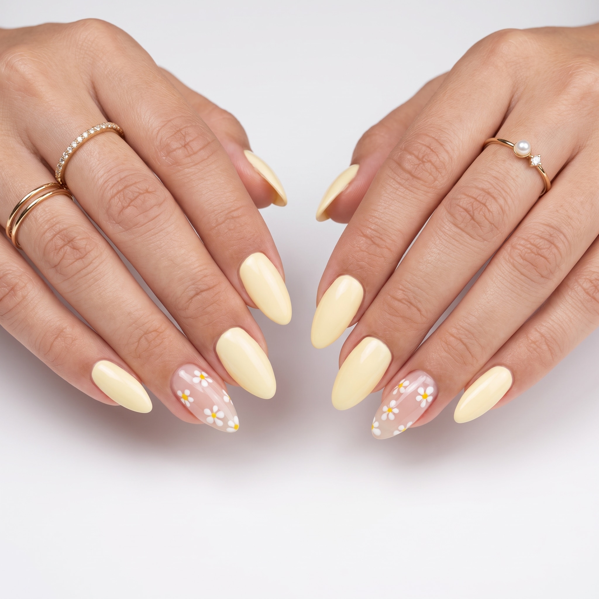 Butter yellow almond nails with fine glitter and floral accent details