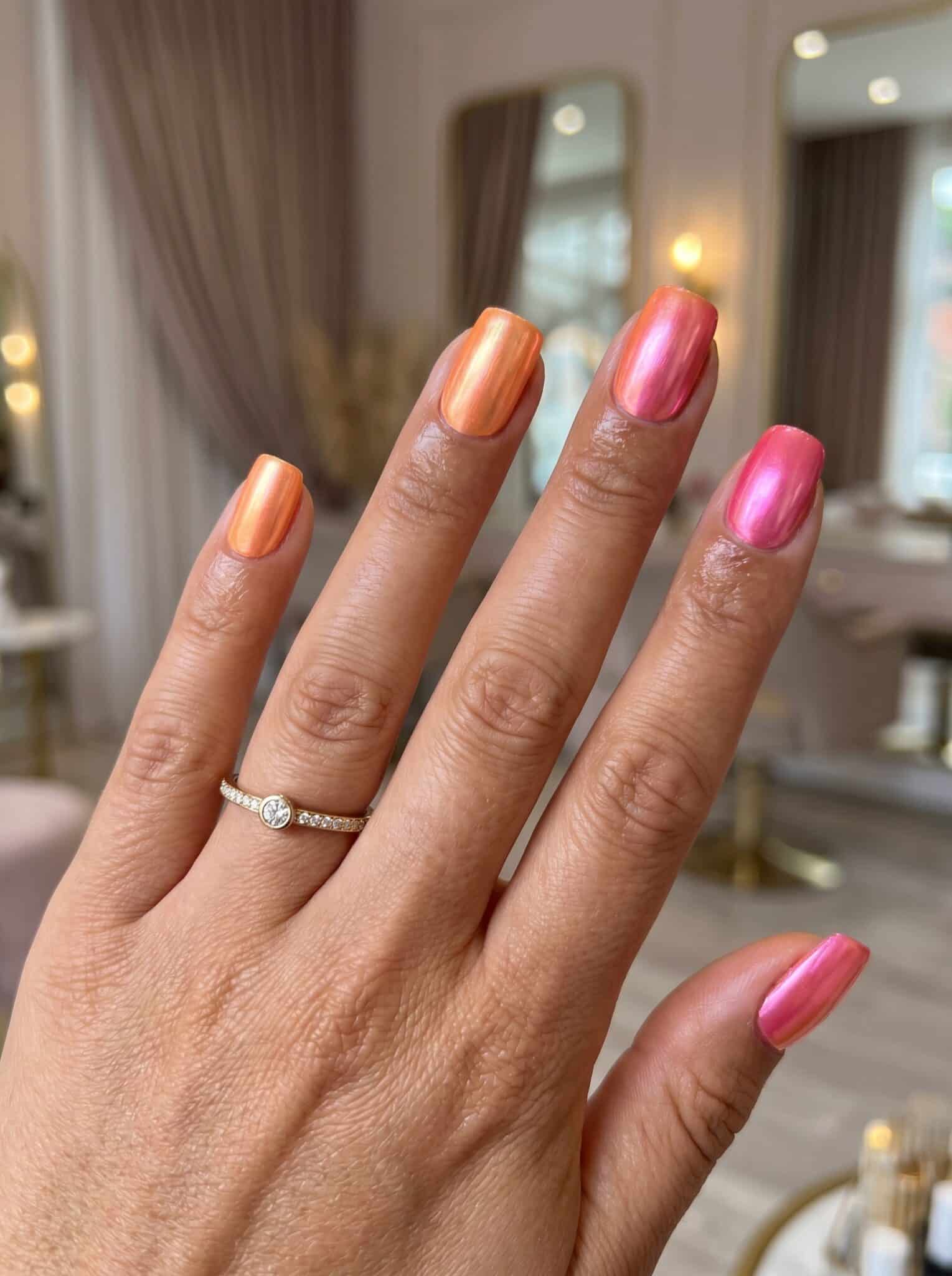 Iridescent blue and pink chrome almond nails with a soft ocean-glazed shine