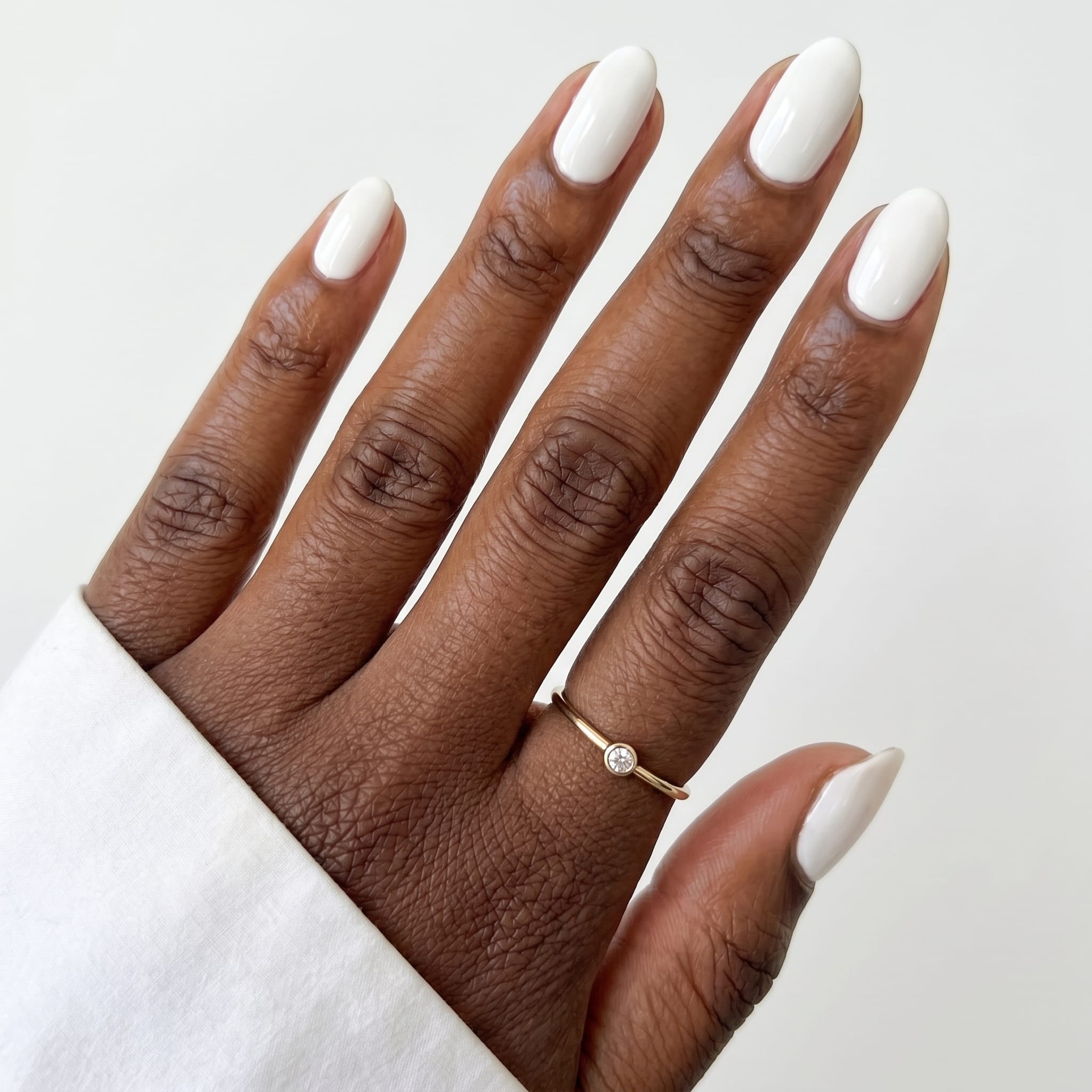 Classic opaque white almond nails with a glossy finish