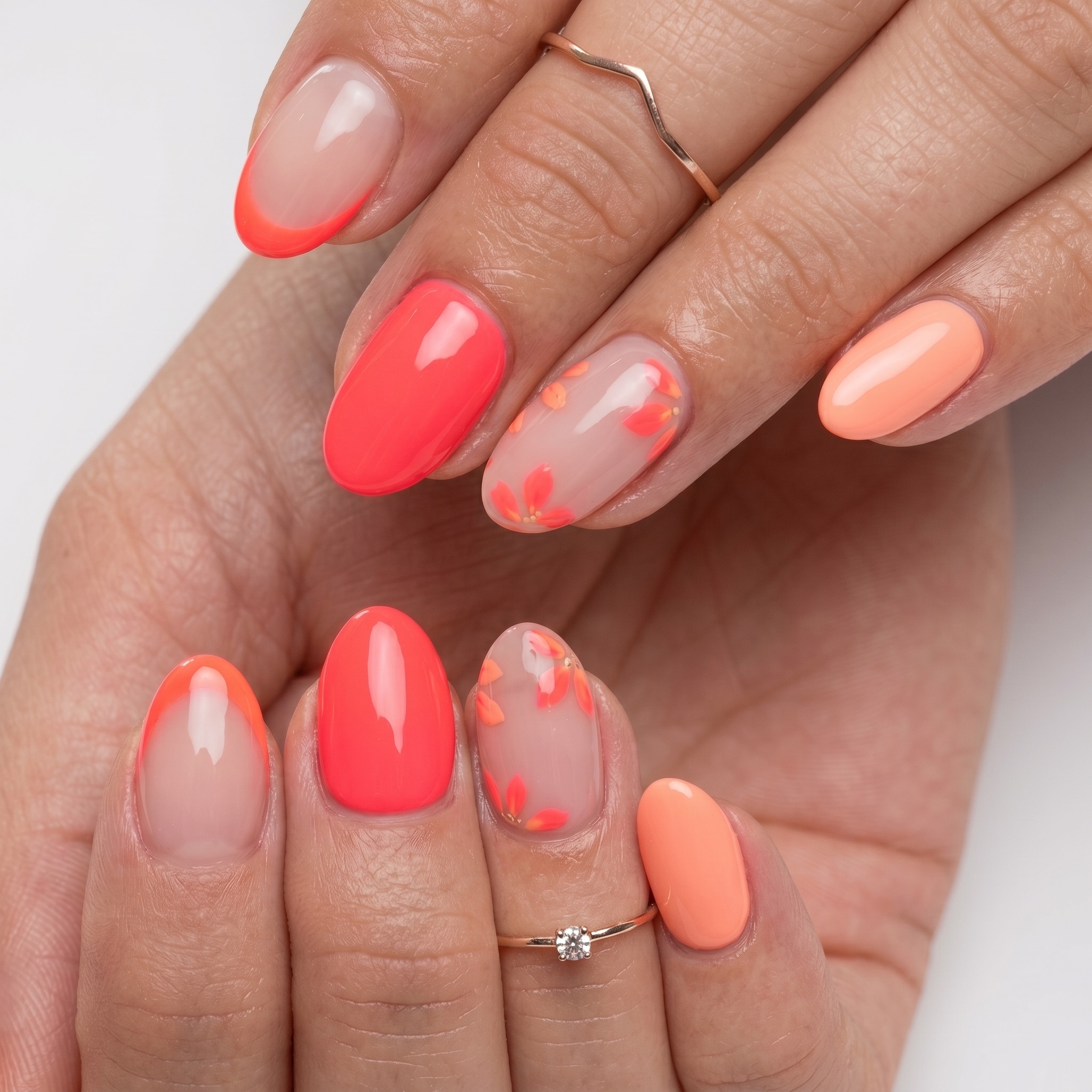 Coral and pink nails with negative-space details and fine accent art