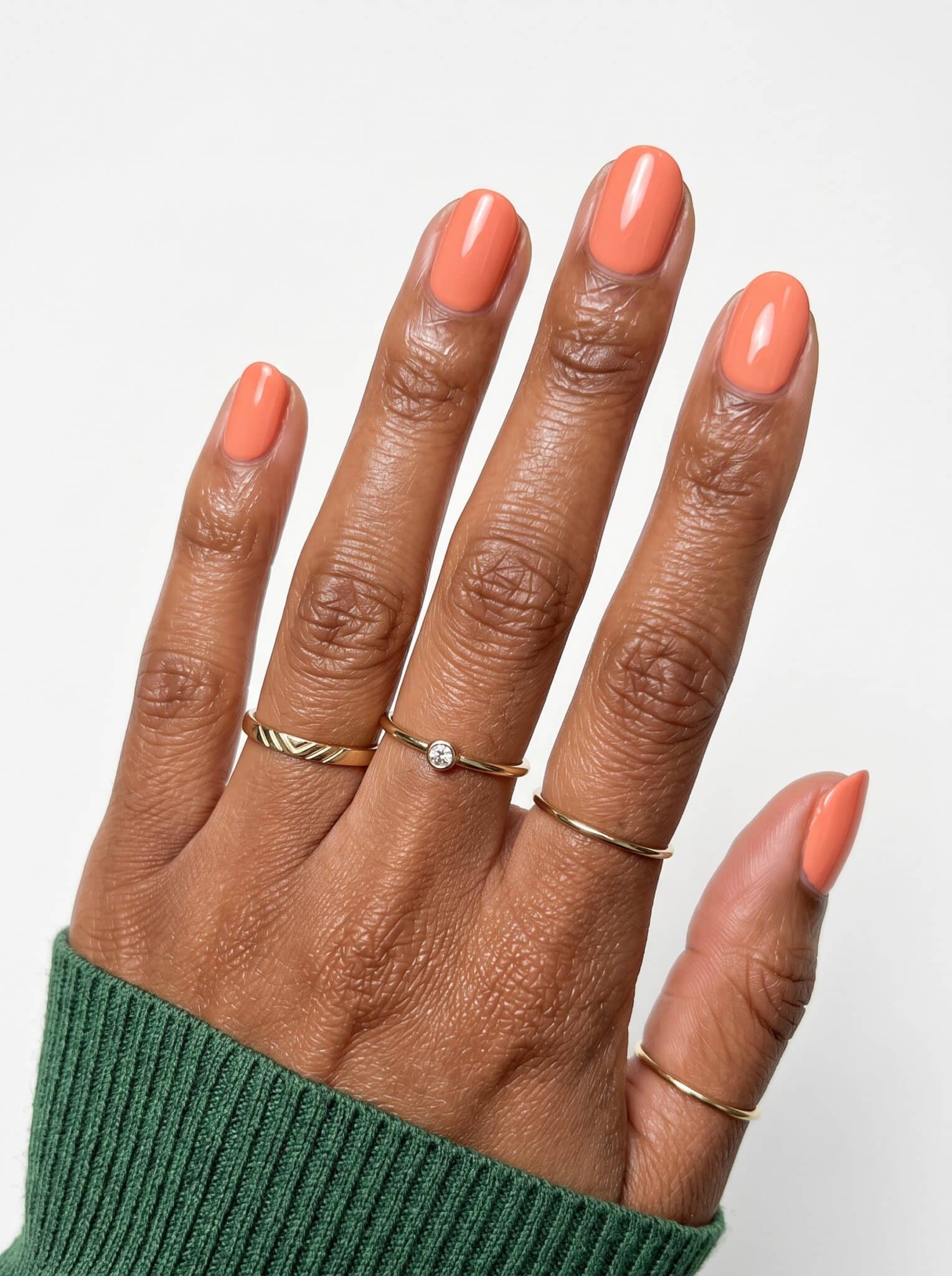 Coral peach glossy almond nails with a smooth summer finish