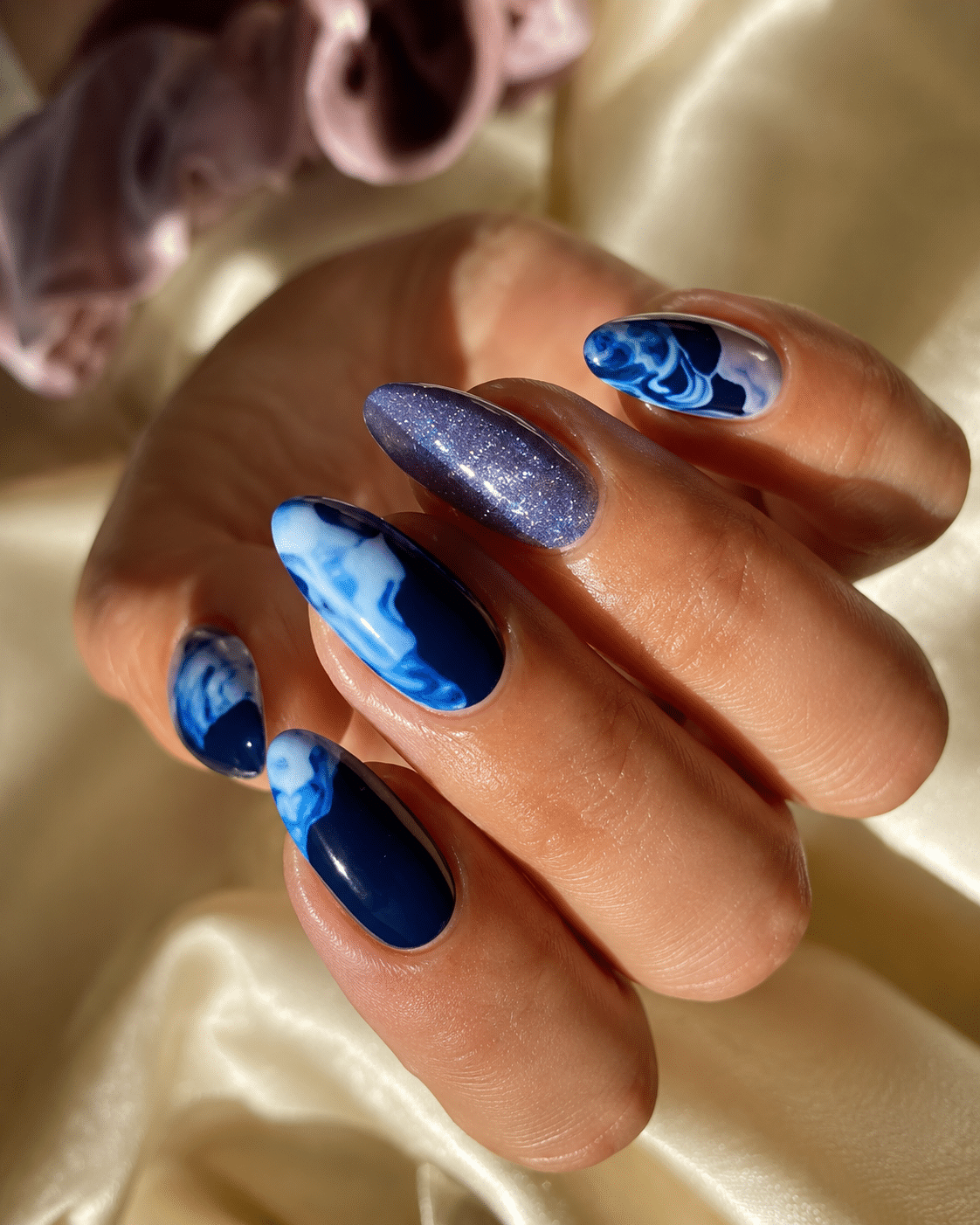Cute blue summer nails with floral accent details and a glossy finish