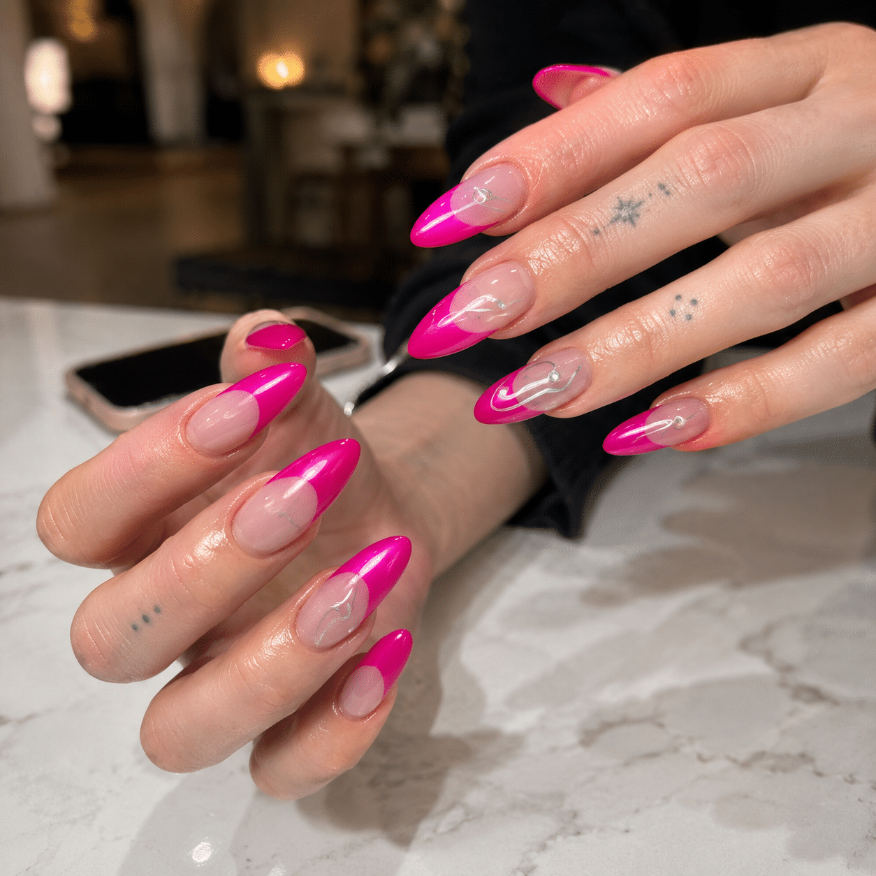 Glossy hot pink almond nails with a clean summer manicure finish