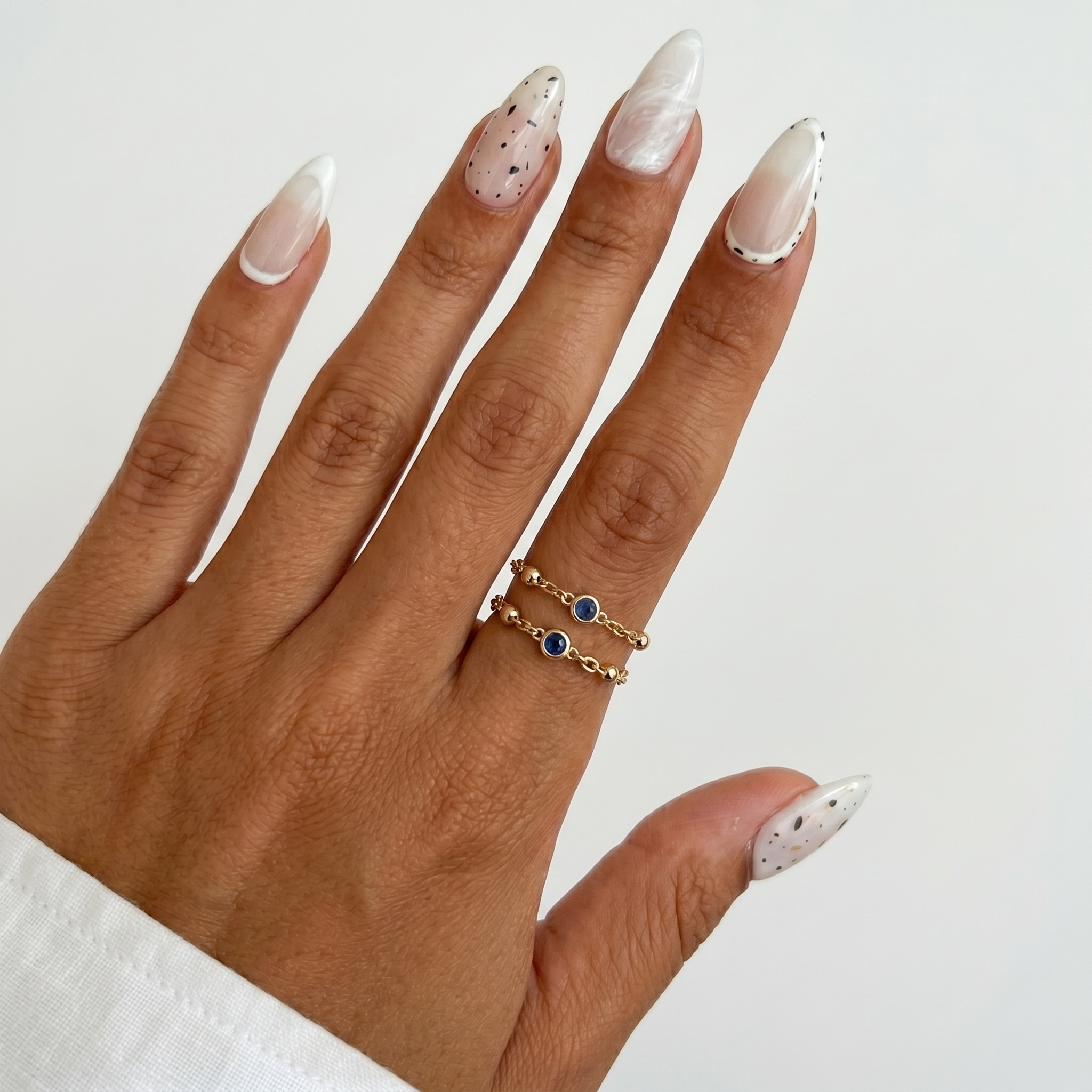 Glossy opaque white almond nails with a smooth clean finish