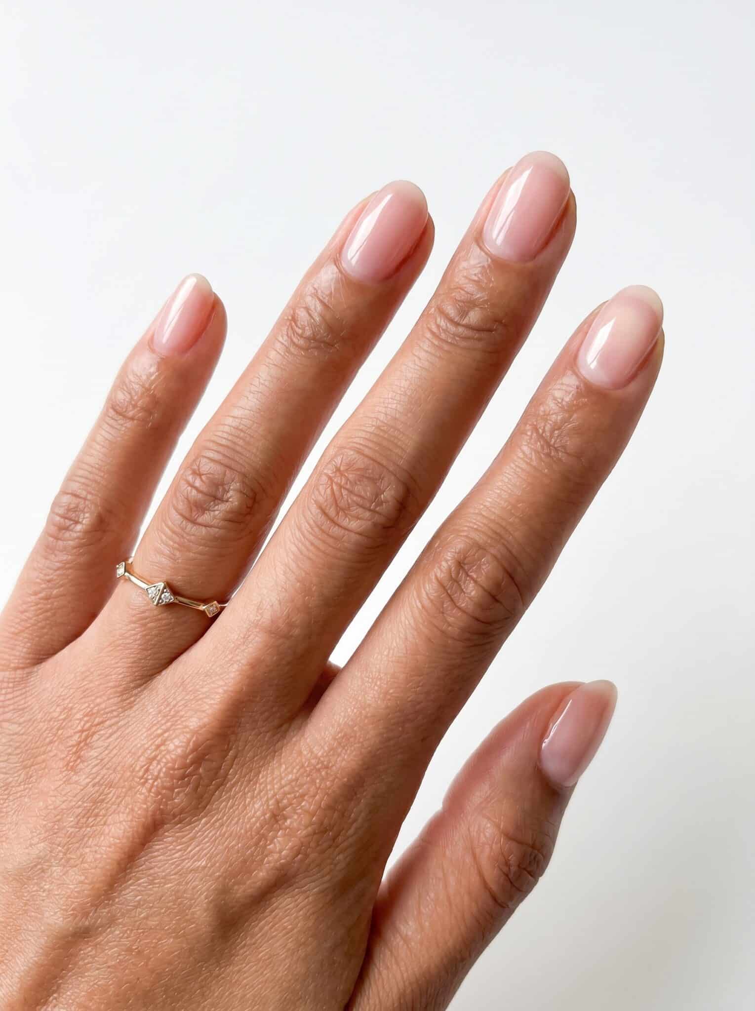 Short rounded nails with a glossy latte nude polish