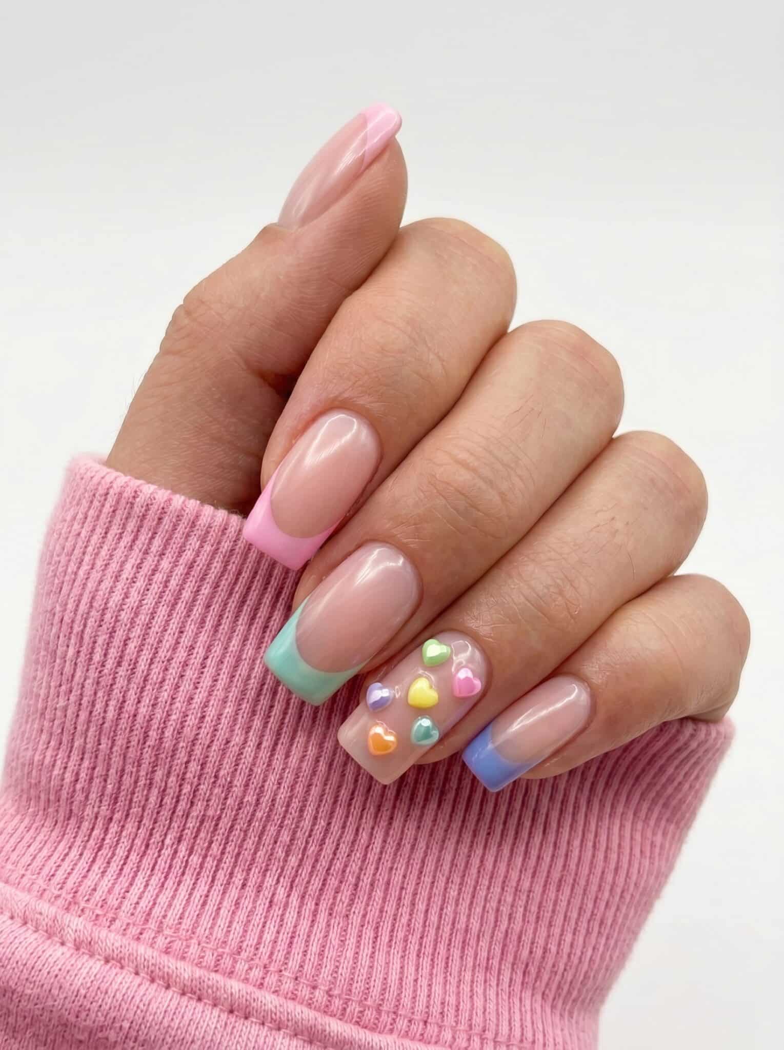 Pink nails with pastel French tips and small raised flower accents