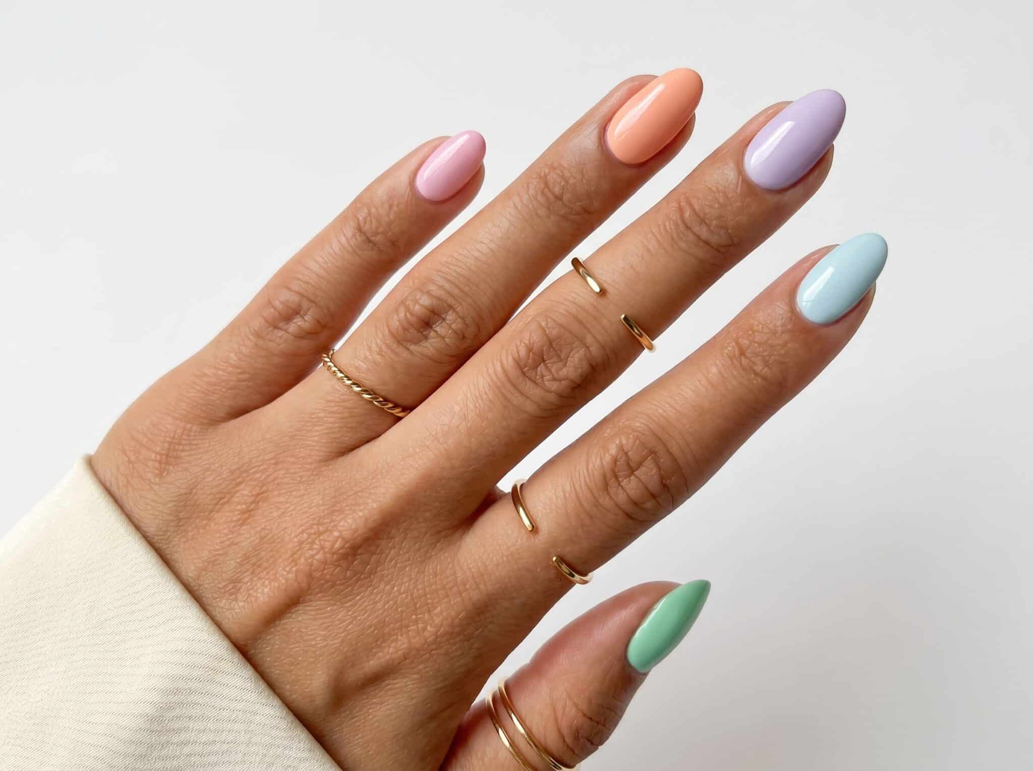 Almond nails with pastel pink, blue, mint, purple, and yellow French tips