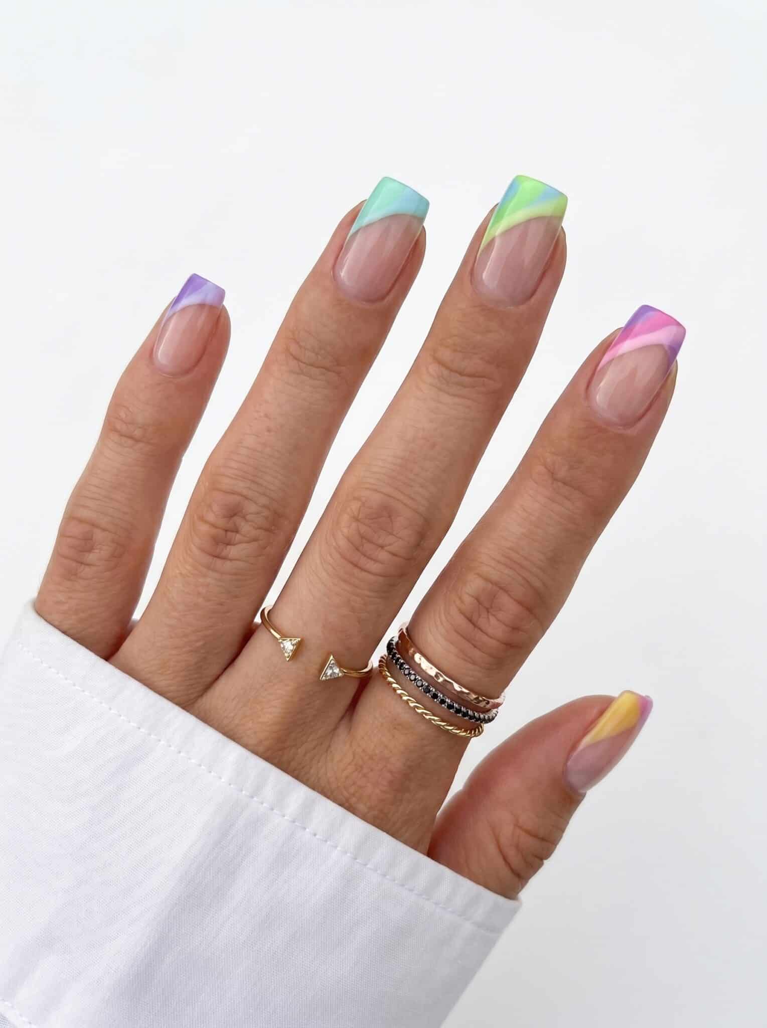 Almond nails with pastel purple, mint, blue, pink, and yellow French tips