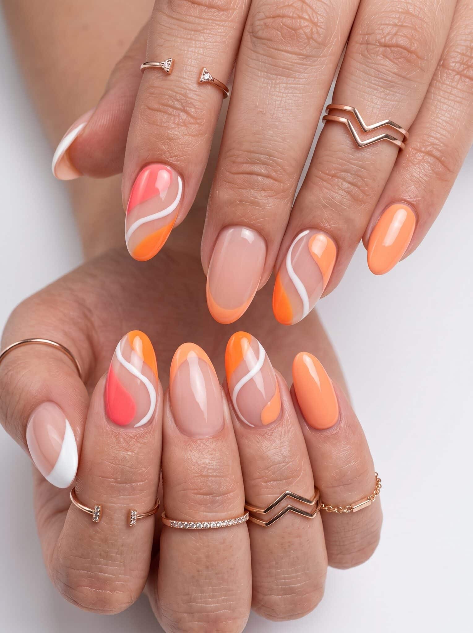 Peach coral summer nails on deep skin with a glossy warm finish