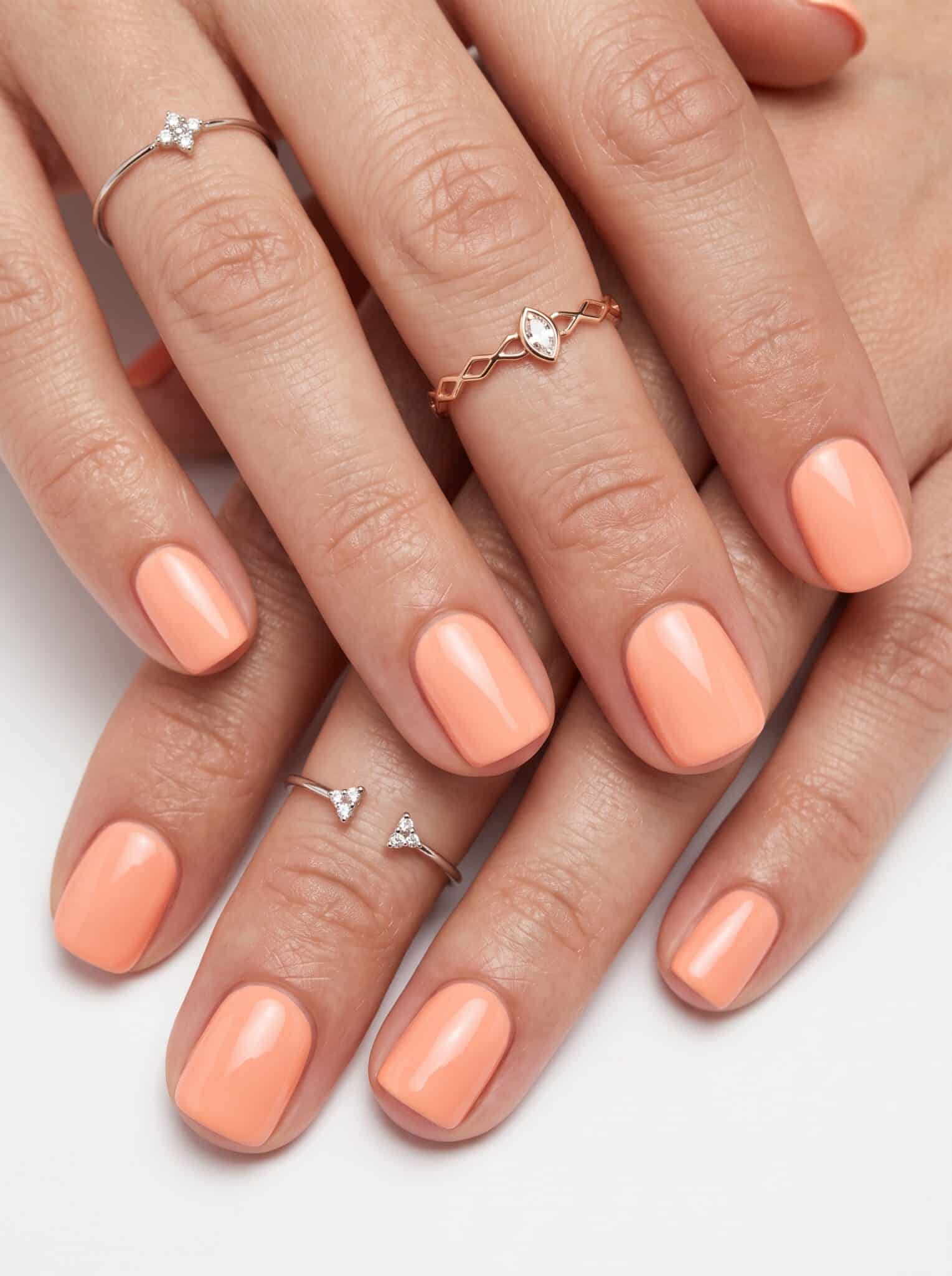 Peach ombre swirl summer nails with coral and white accents