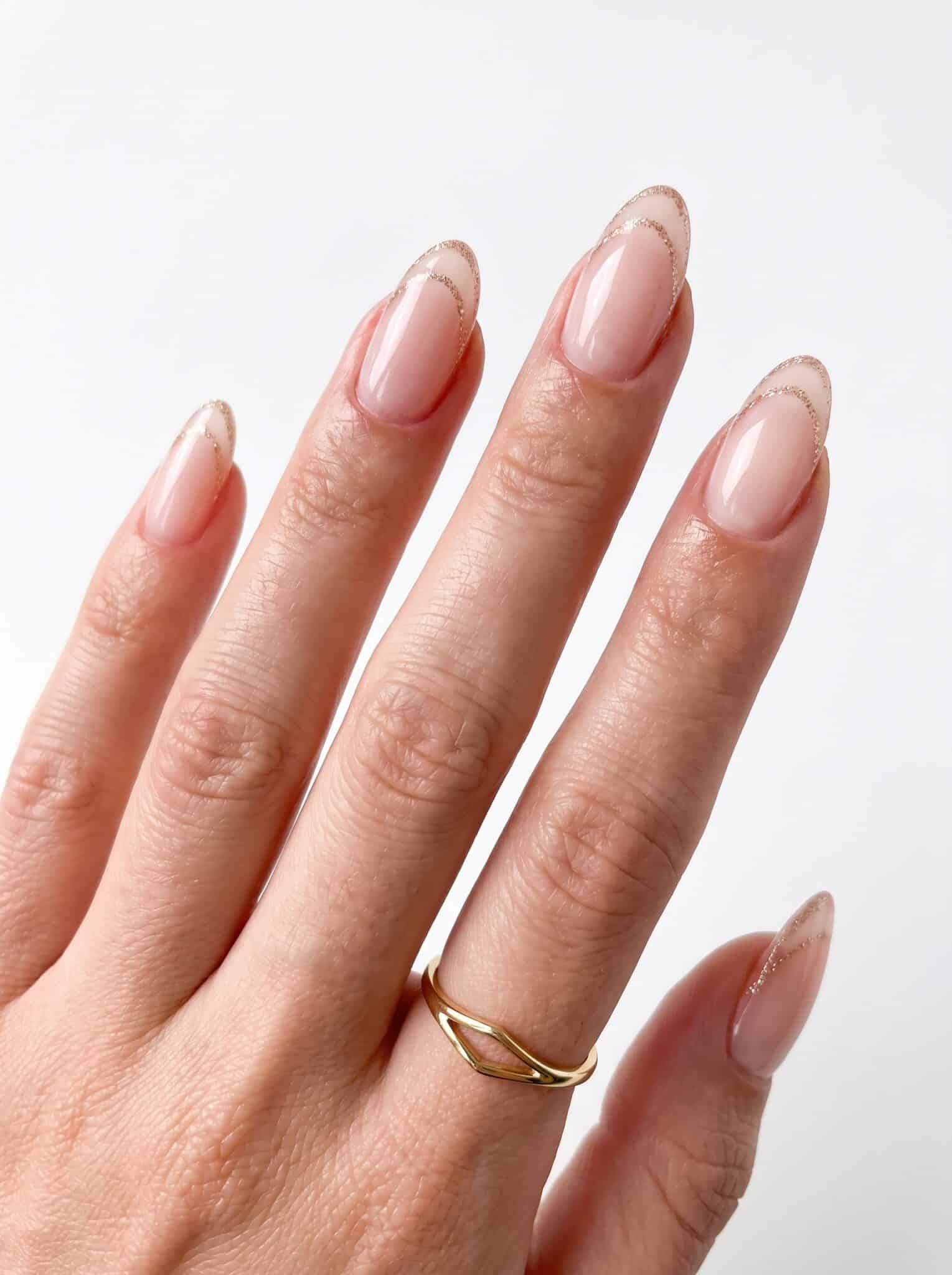 Peachy nude nails with a soft glossy almond shape