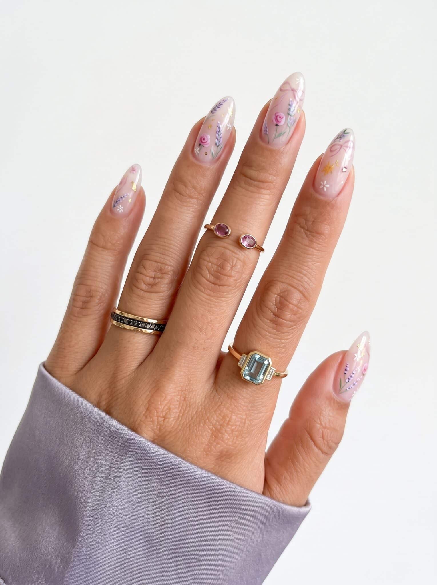 Nude nails with pink, lilac, and bright pink French tip accents