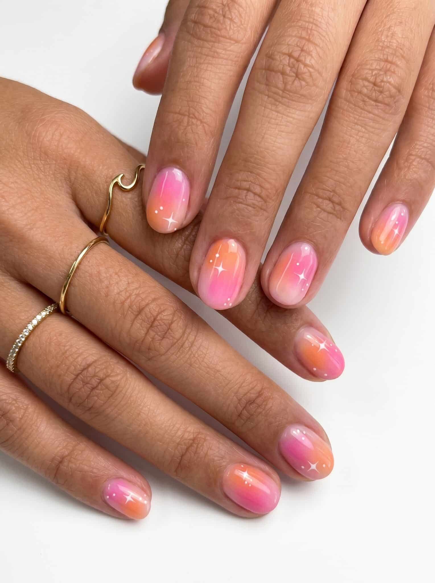 Short nails with a pink and orange gradient finish
