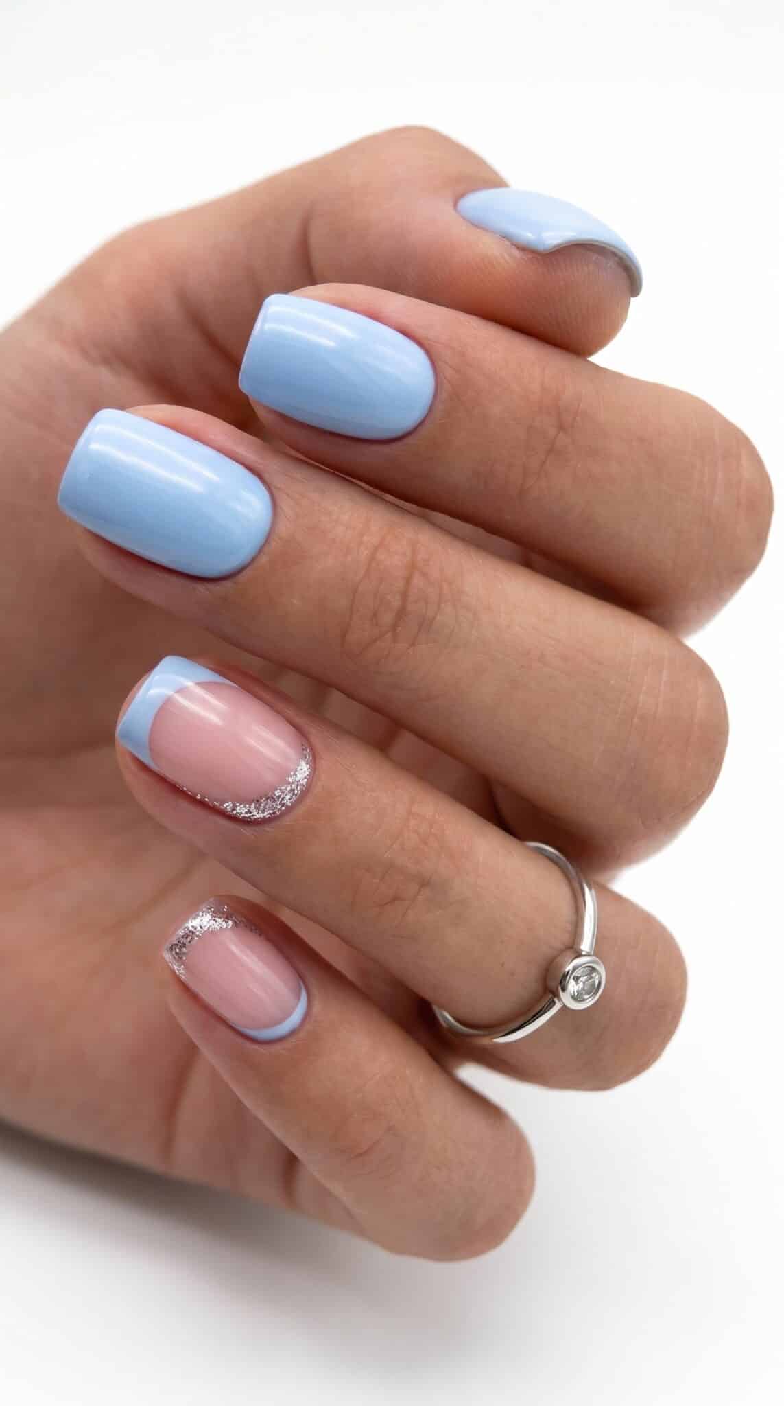 Short nails with sky blue polish and soft pink accent details