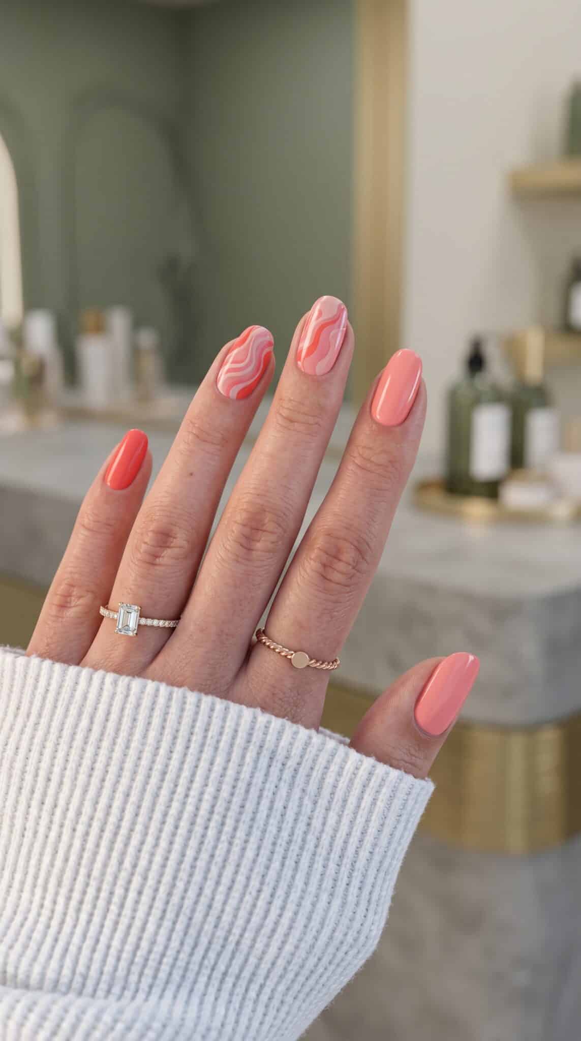 Glossy peach almond nails with a soft nude-peach base and clean summer finish