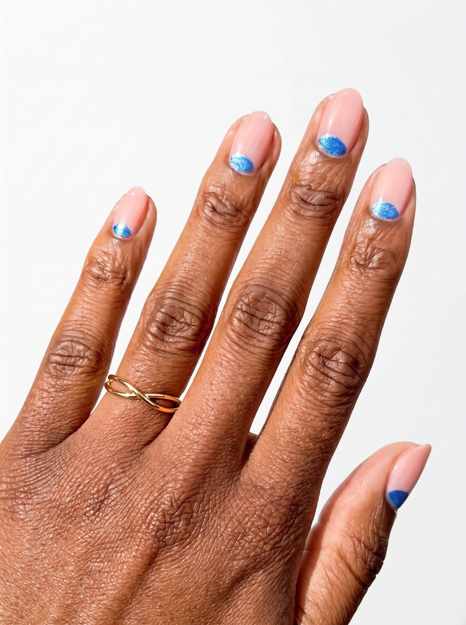 Nude short nails with tiny blue floral accent details