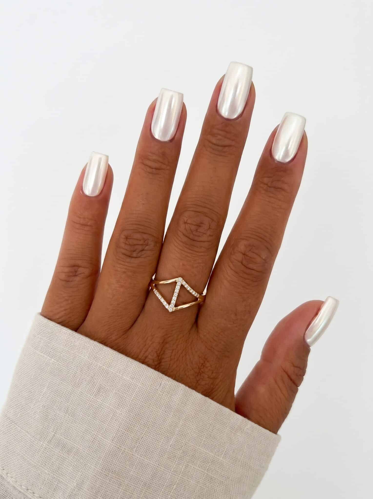 Nude nails with sharp white diagonal French tip details