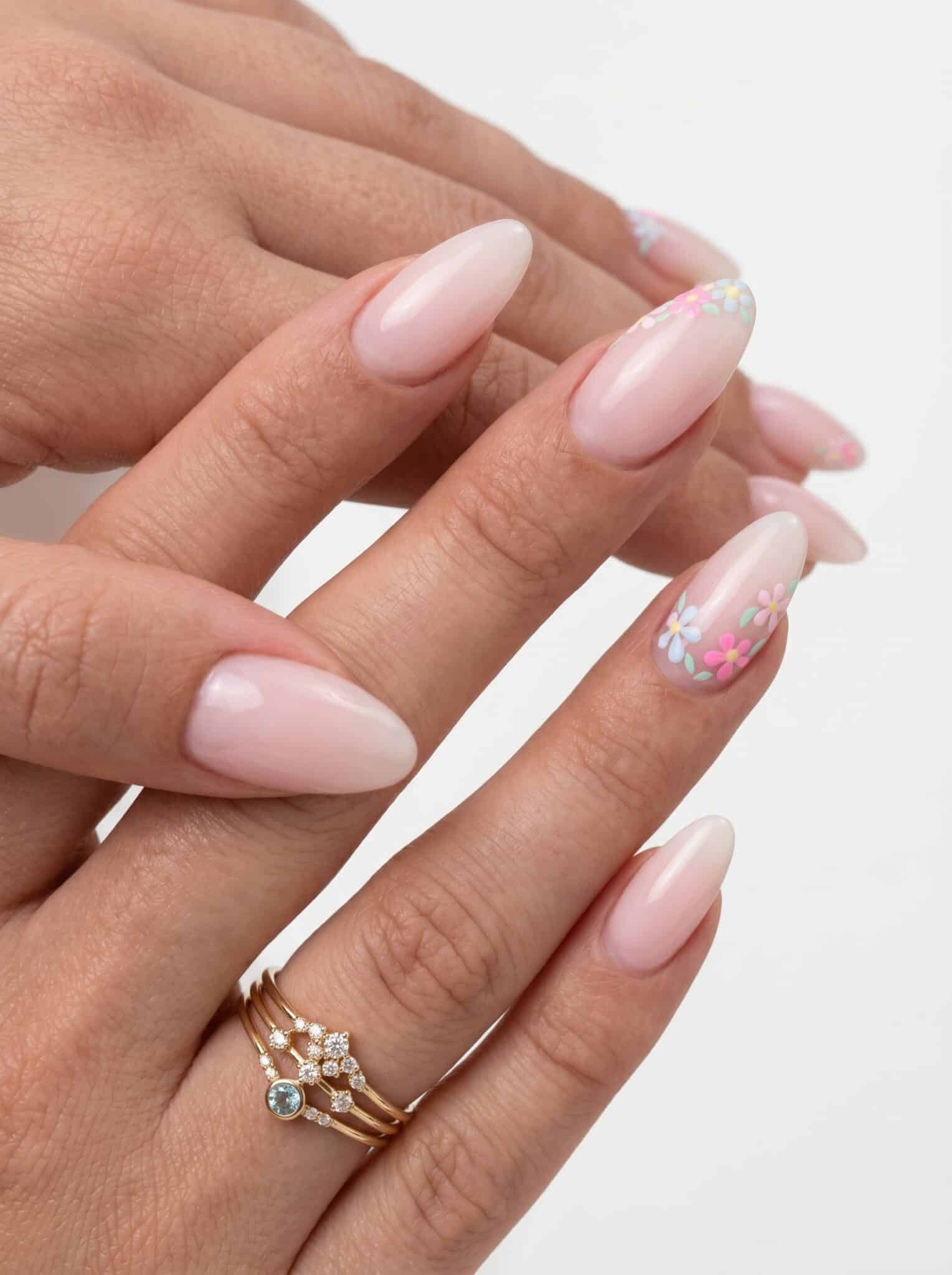 White French tip nails with small gold star accents on a nude base