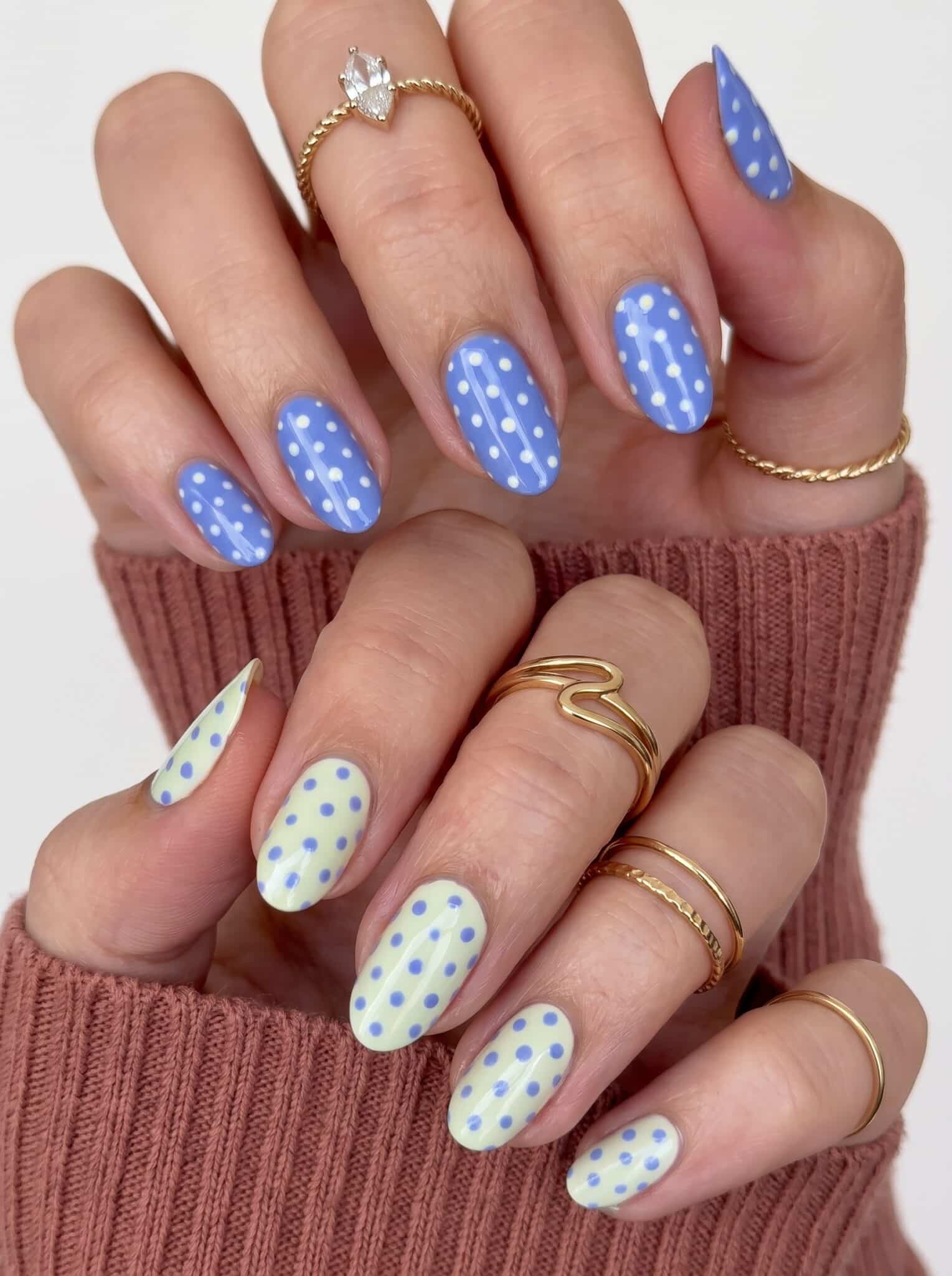Glossy white nails with tiny neon pink yellow and green dot accents
