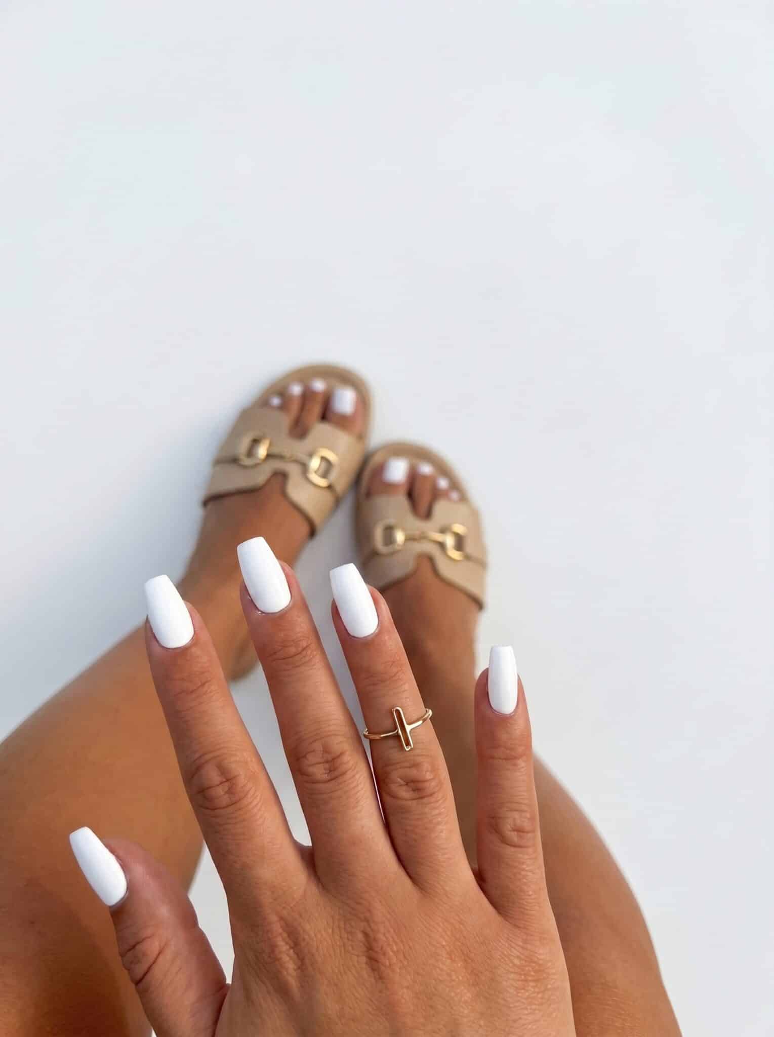 Nude almond nails with thin white outline French tip details