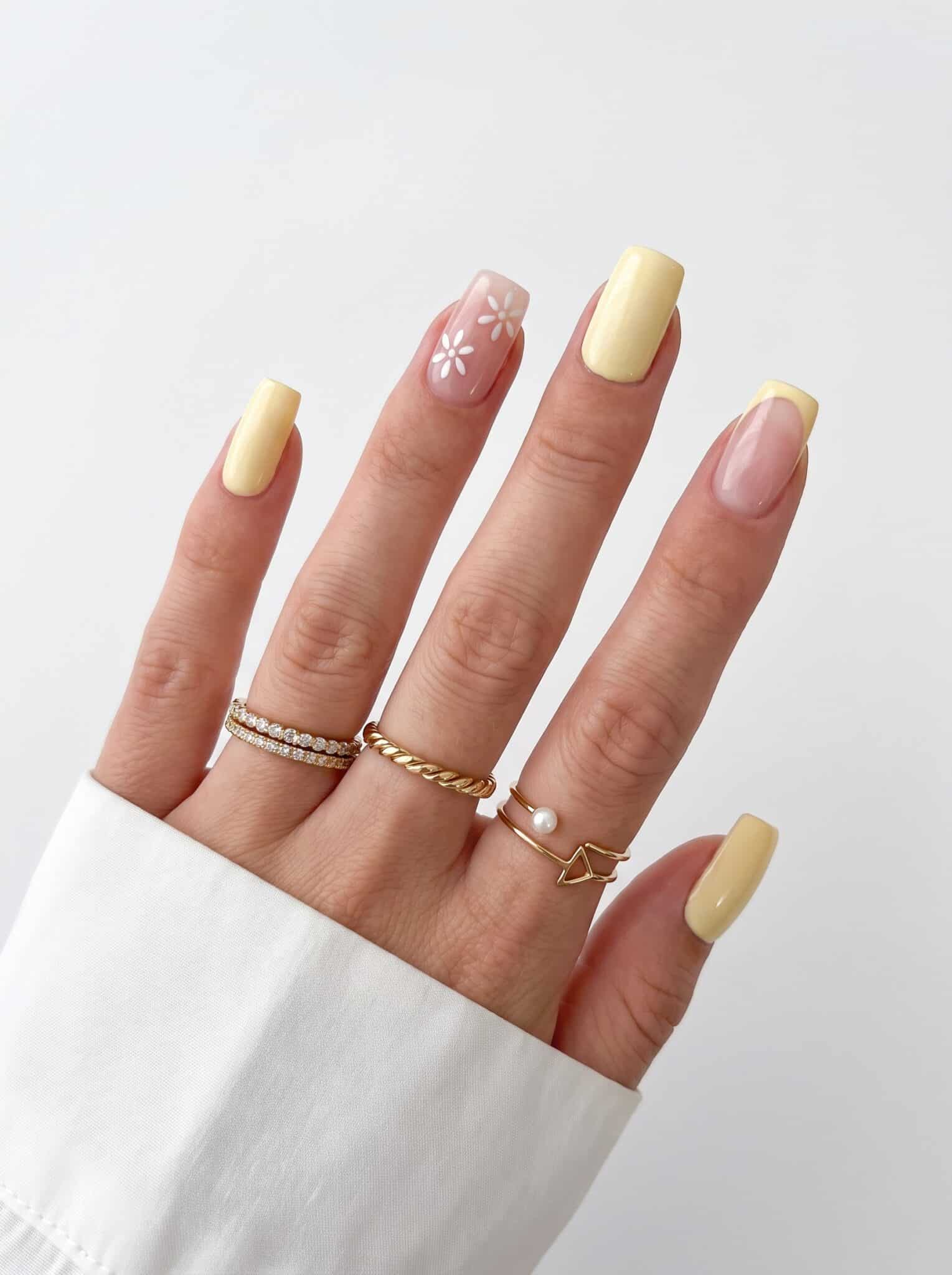 Yellow almond nails with white daisy and glossy accent details