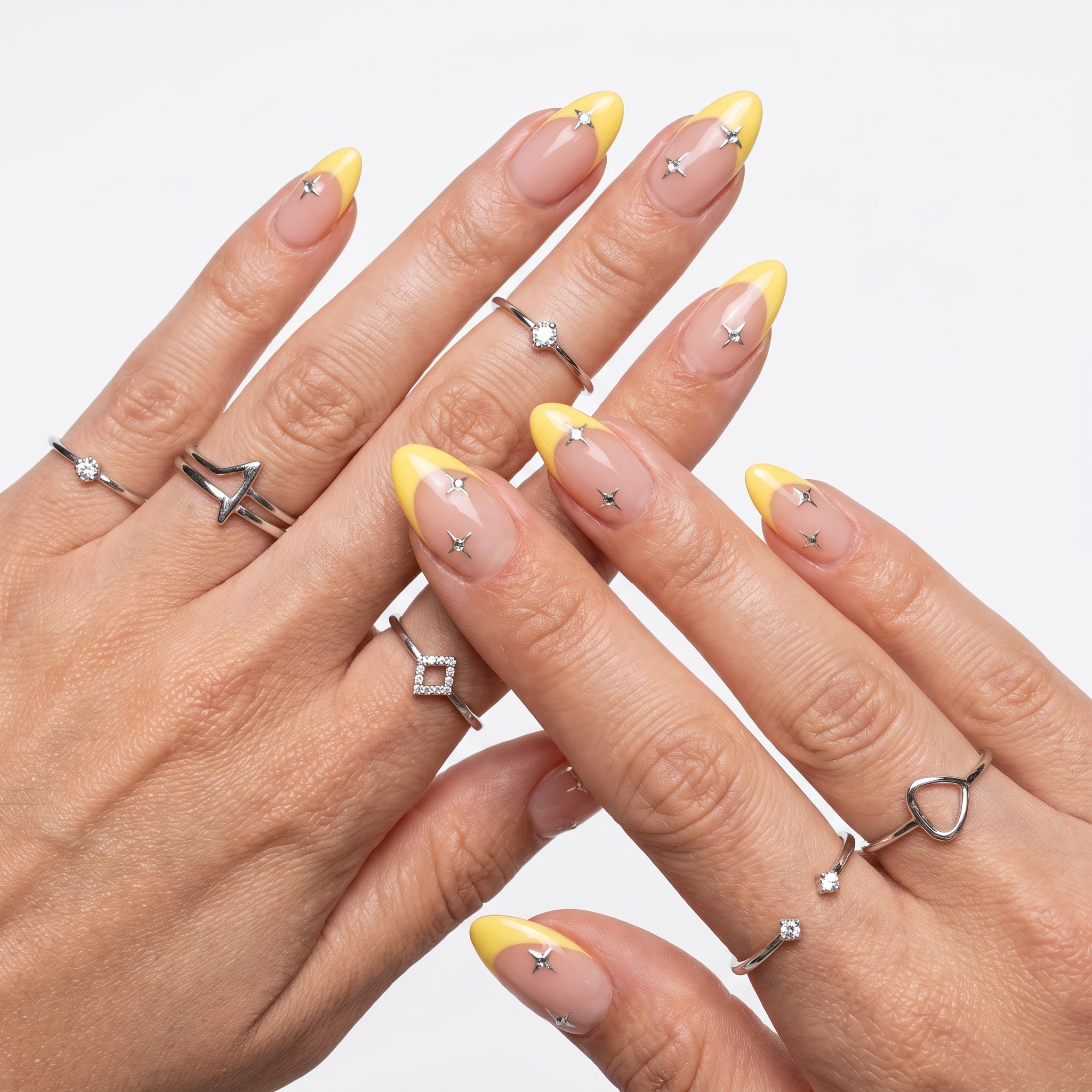 Nude almond nails with fine yellow micro French tips and small minimal details