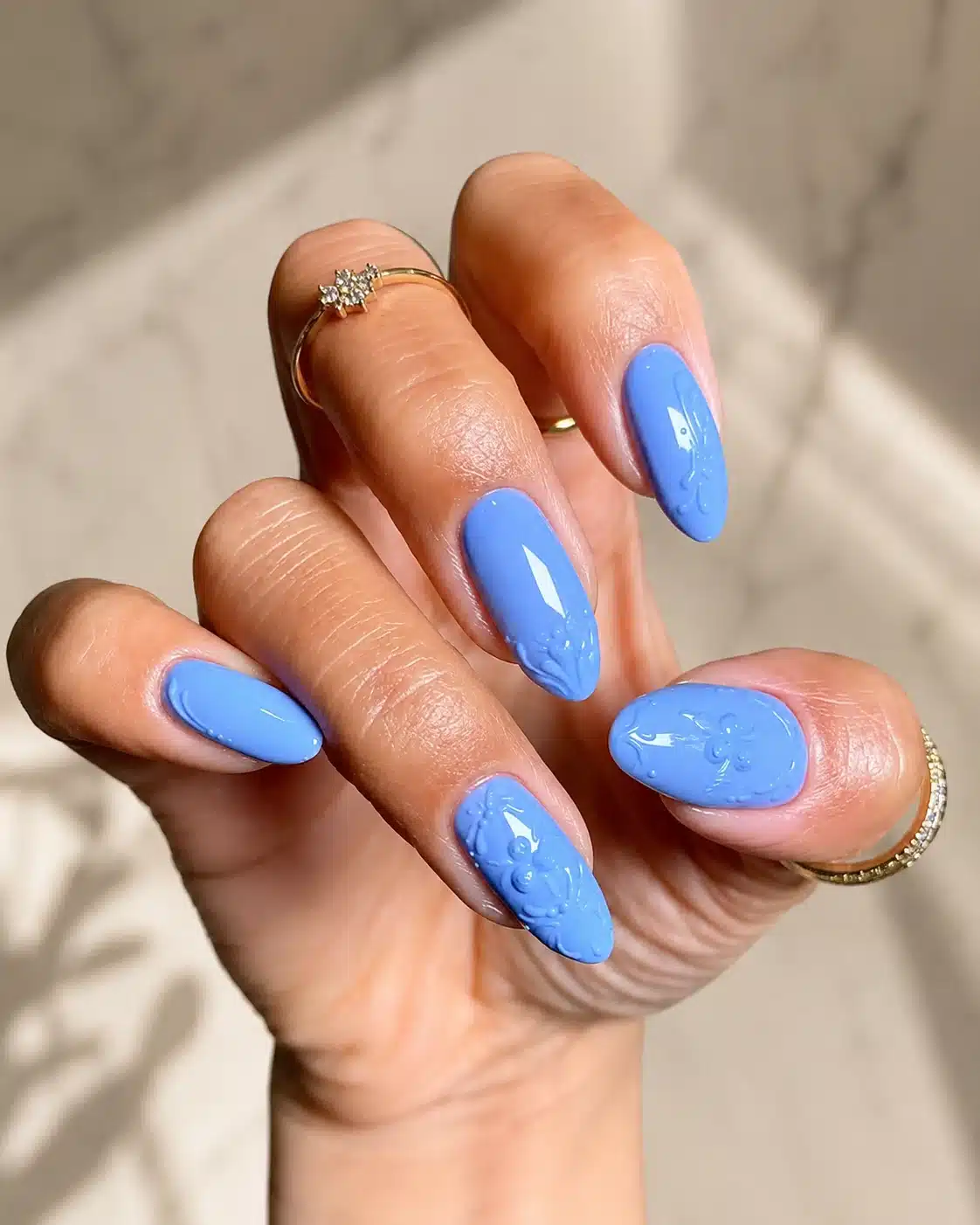 Glossy sky blue summer nails in an oval shape