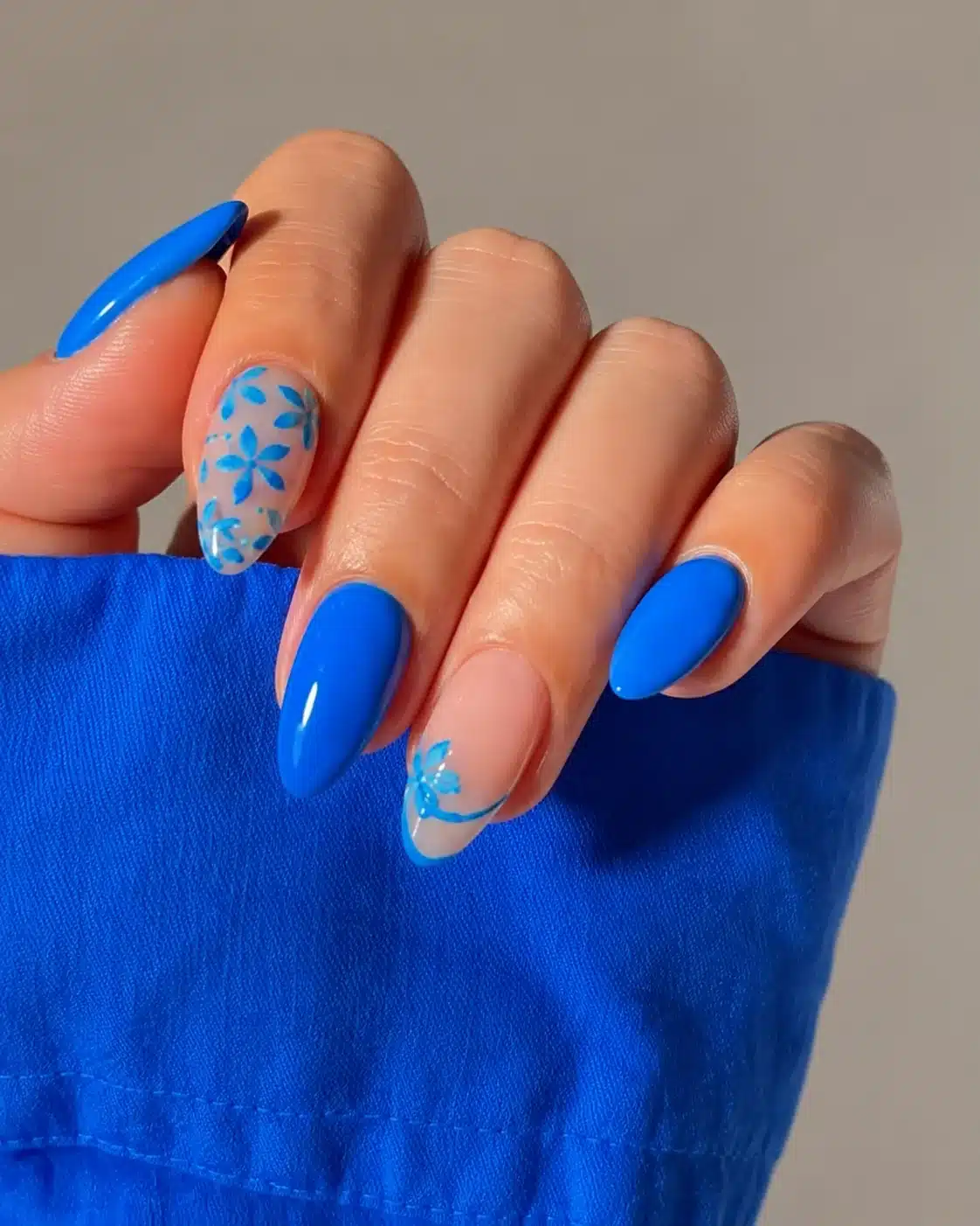Cobalt blue summer nails with a floral accent