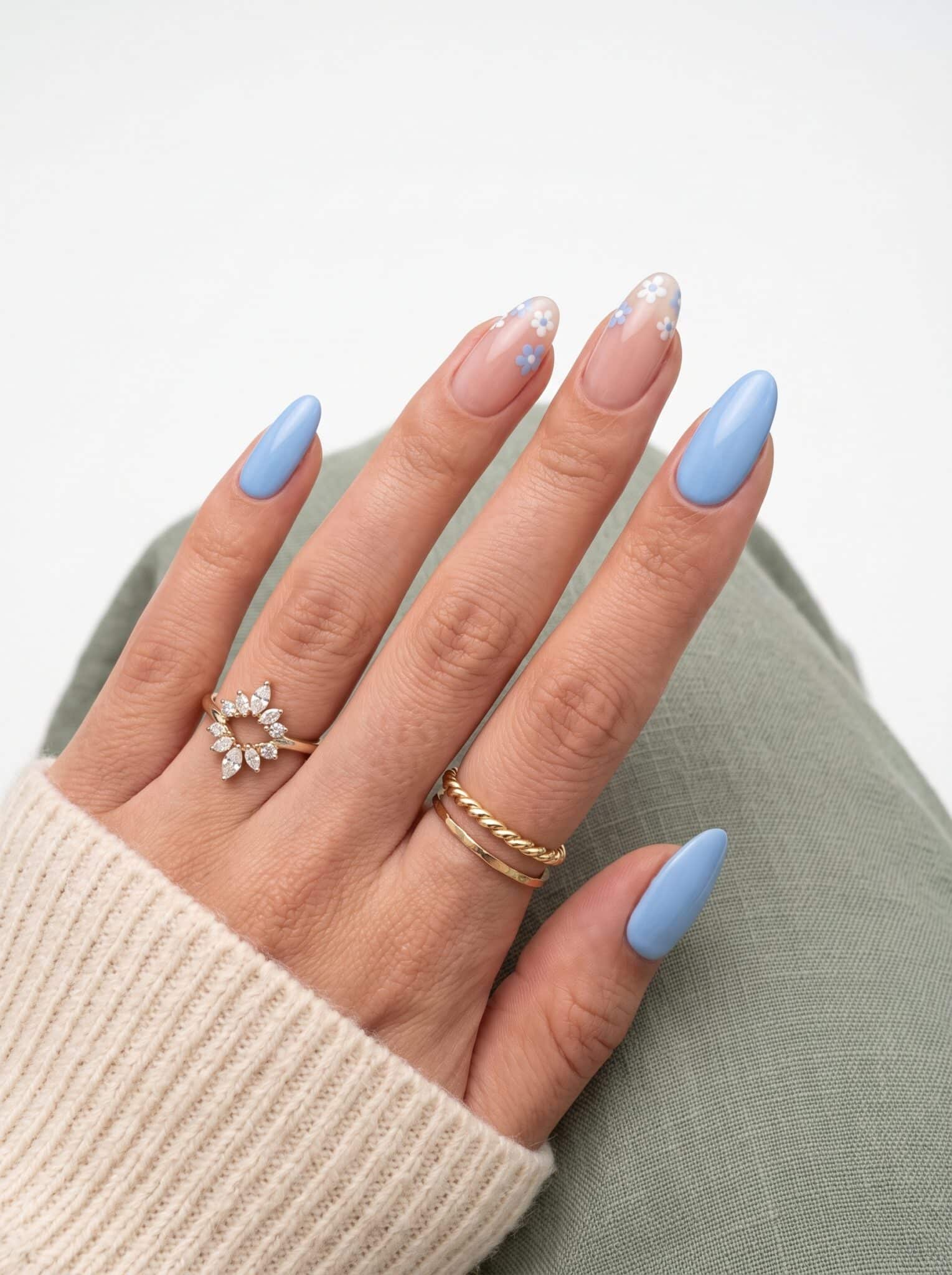 Blue French tip summer nails with delicate white flower accents