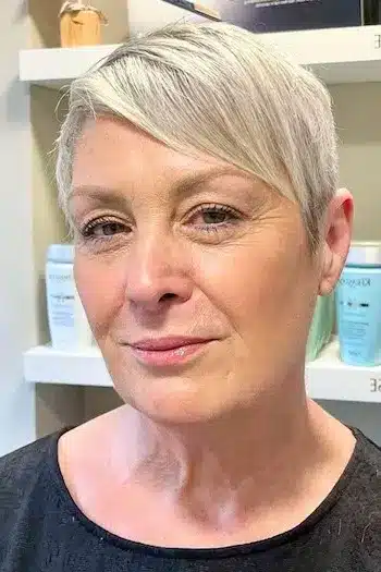 Pixie Haircuts for Women Over 60 With Fine Hair - Silver Side-Swept Pixie with Tapered Sides Hairstyle