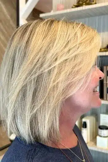 Pixie Haircuts for Women Over 60 With Fine Hair - Straight Layered Long Bob Hairstyle, side view.