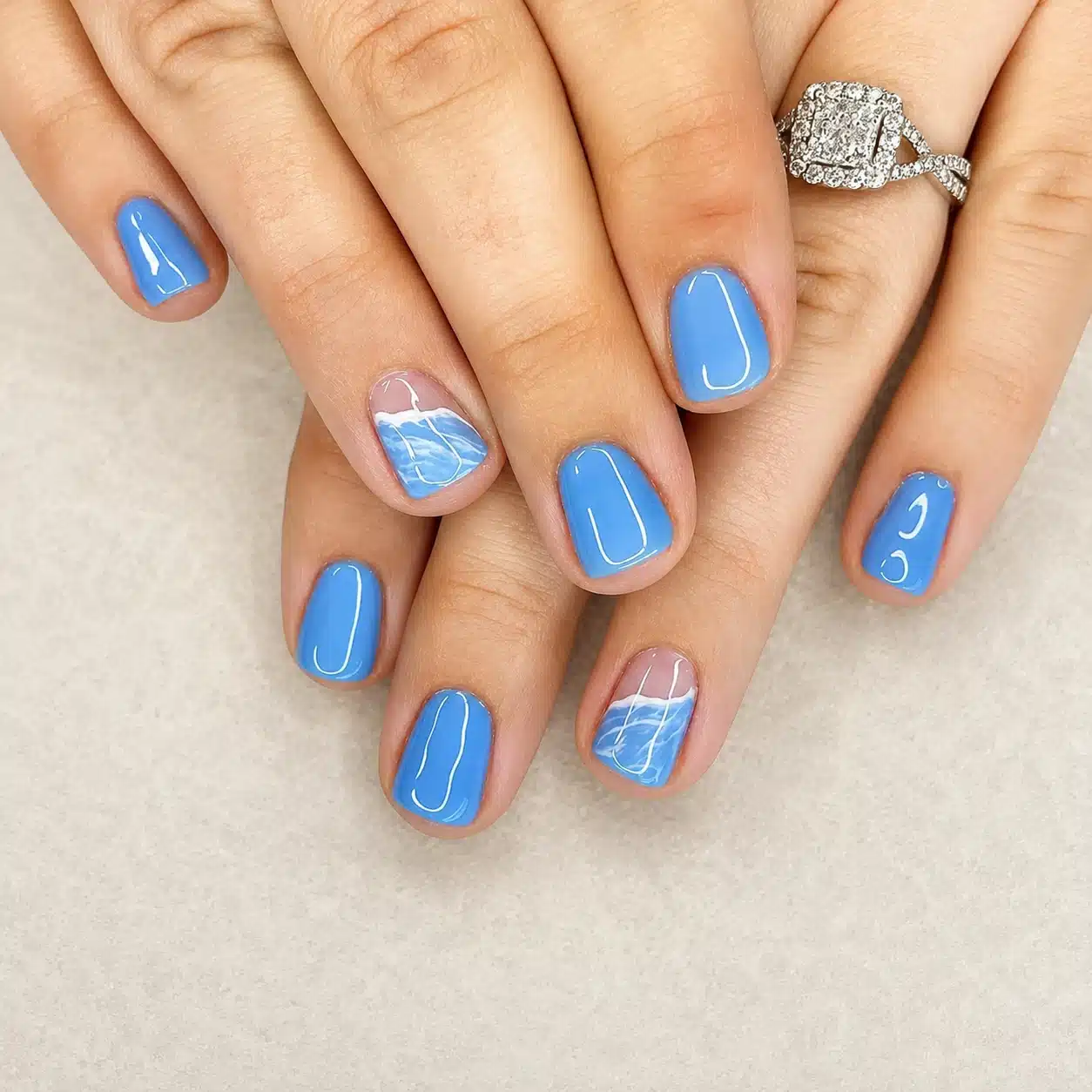 Blue summer gel nails with glossy nail art