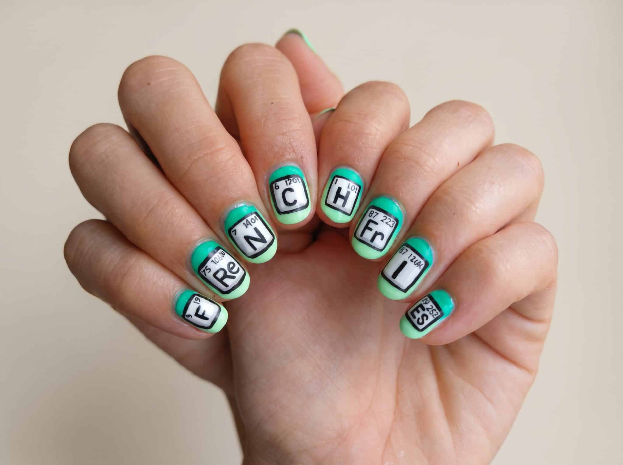 apple back to school nails with glossy red manicure and school themed accent