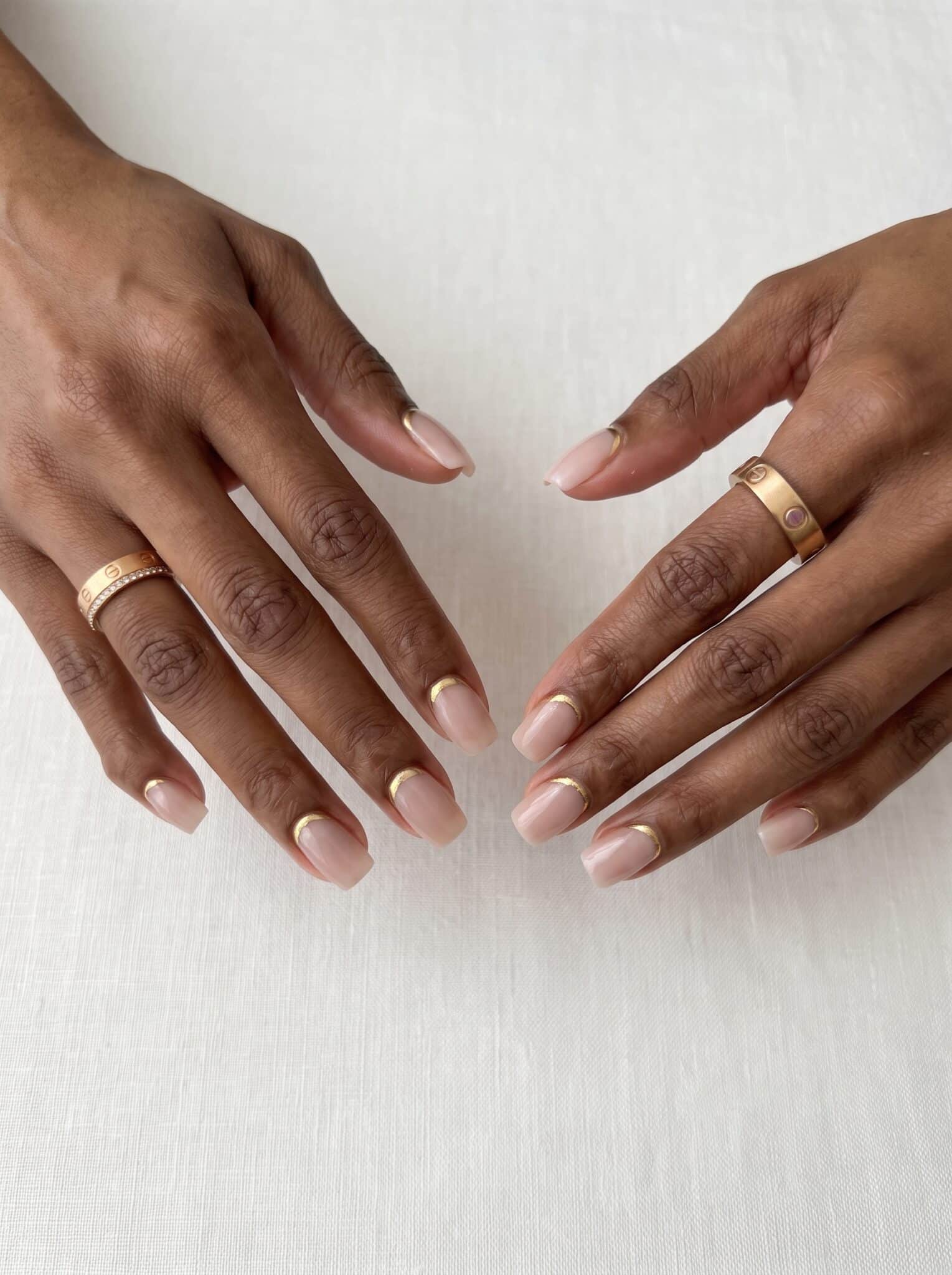beachy nude nails with seashell pearl details and glossy neutral base