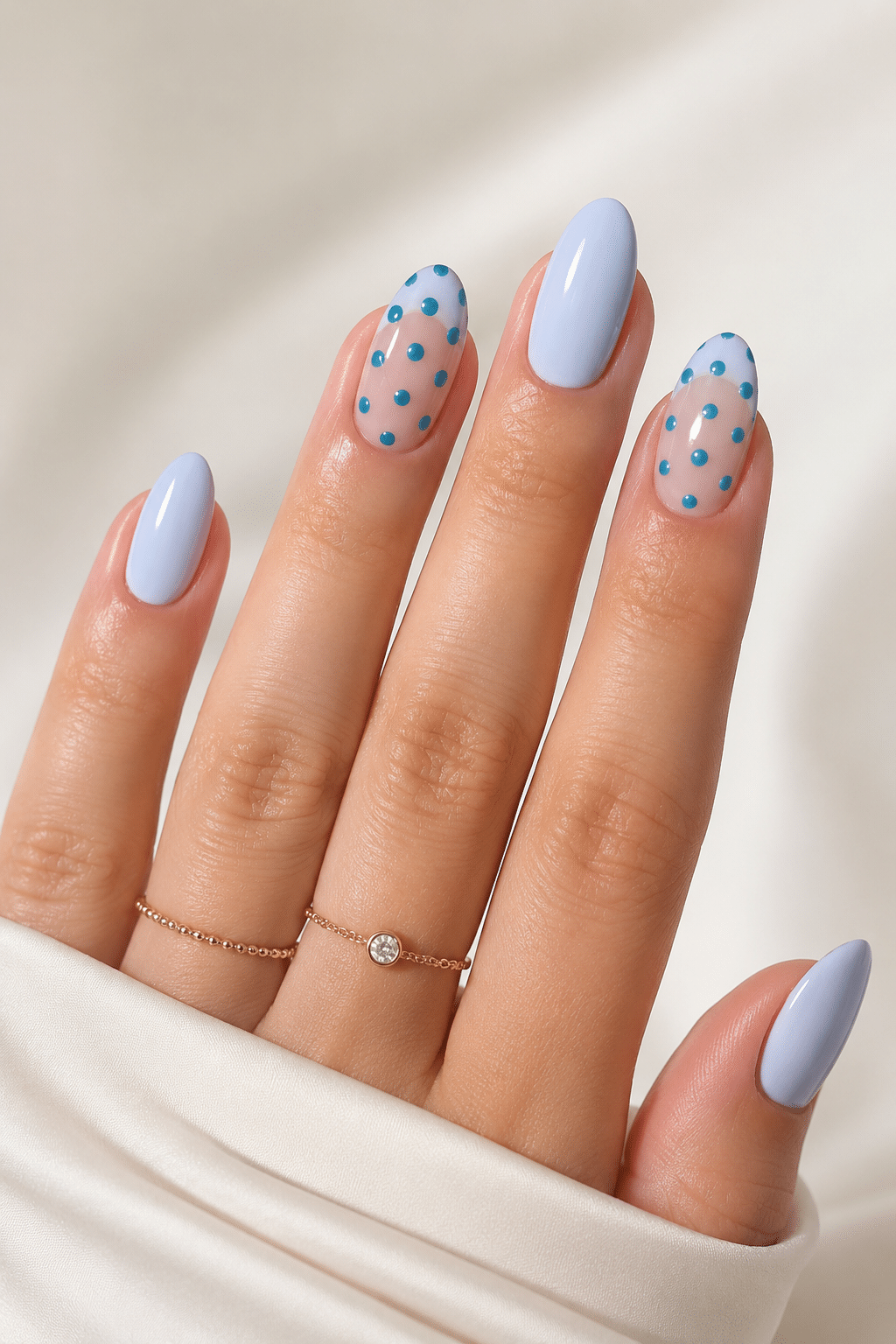 Blue polka dot summer nails with a playful glossy manicure finish