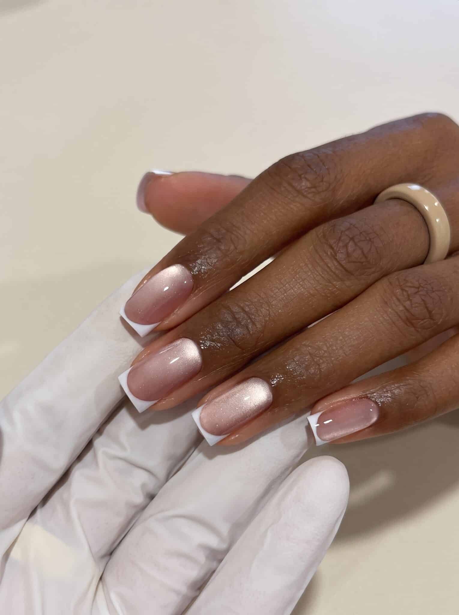 cat eye french neutral nails with shimmer base and white french tips