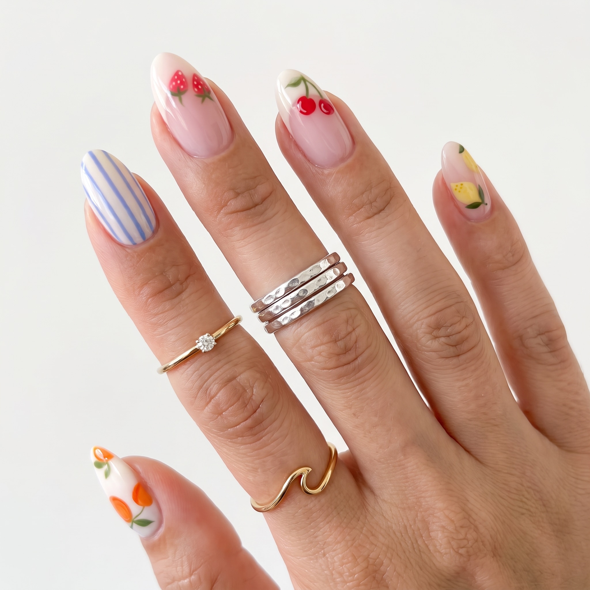 Cherry and stripe accent nails with peach summer color