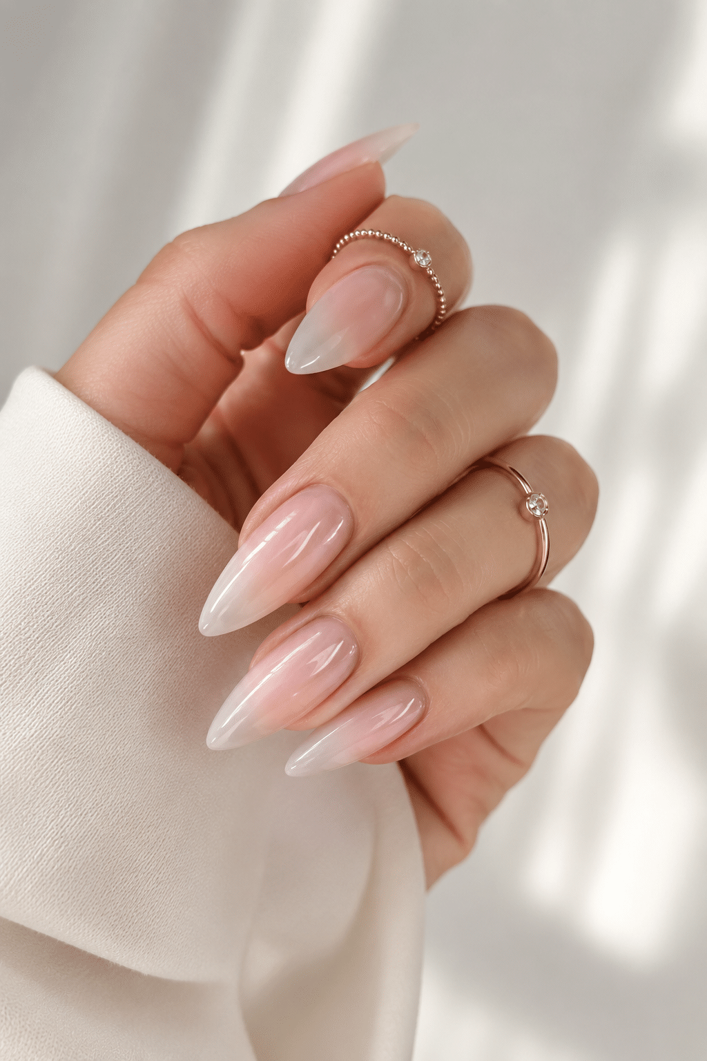 Sheer nude almond summer nails with a clean glossy finish