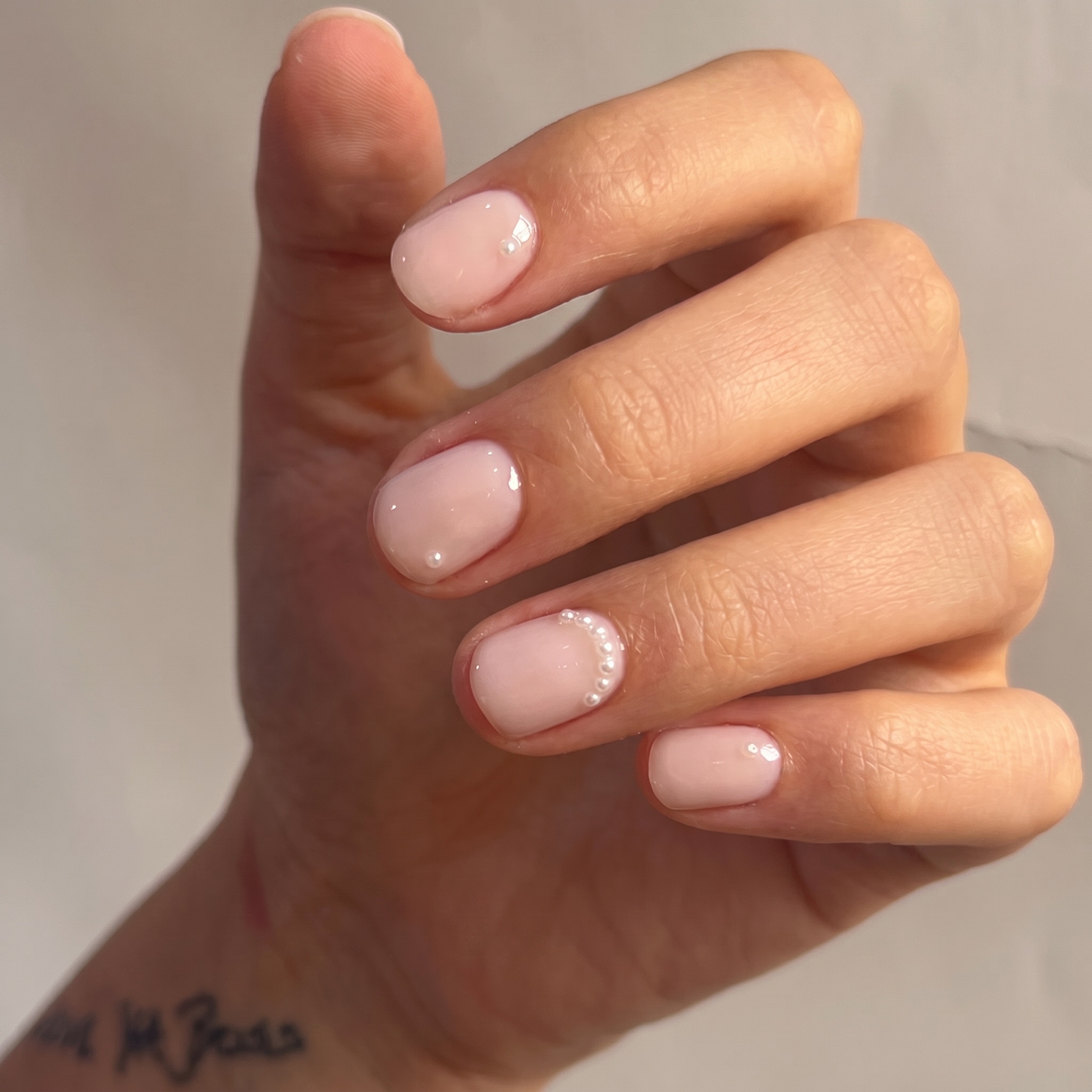 trimmed in gold neutral nails with milky nude base and chrome cuticle accents
