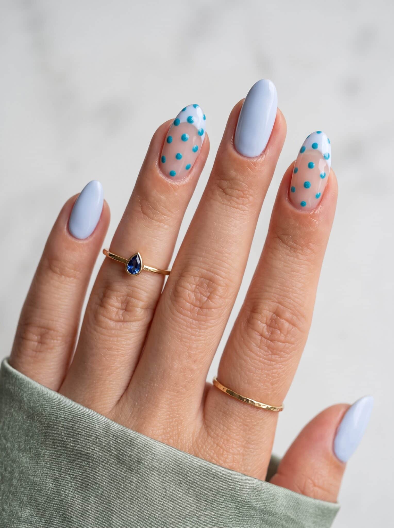 Blue polka dot nail designs summer 2026 with soft pastel polish and tiny dot accents