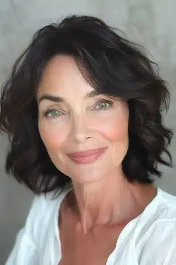 34 Elegant Short Hairstyles for Women Over 70 with Fine Hair 38 Short Hairstyles for Women Over 70 With Fine Hair - Waves with Side-Swept Bangs Hairstyle on Smiling Woman in her 60s.