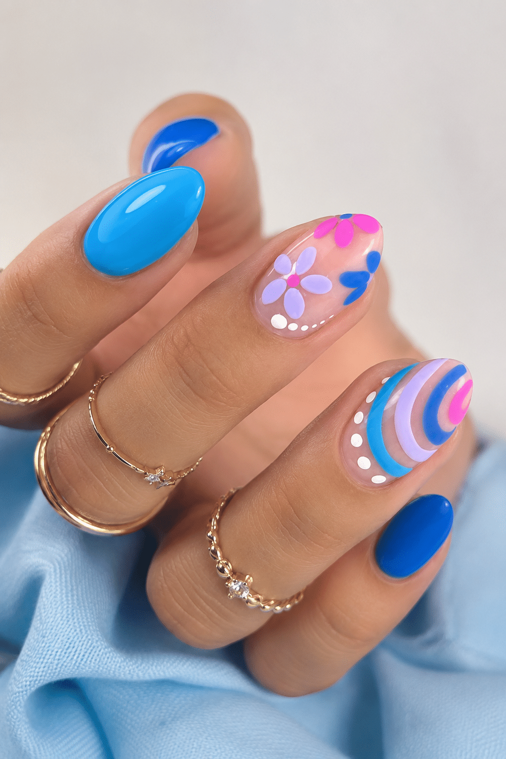 summer almond nails 2026 with bright blue vacation nail art and glossy finish